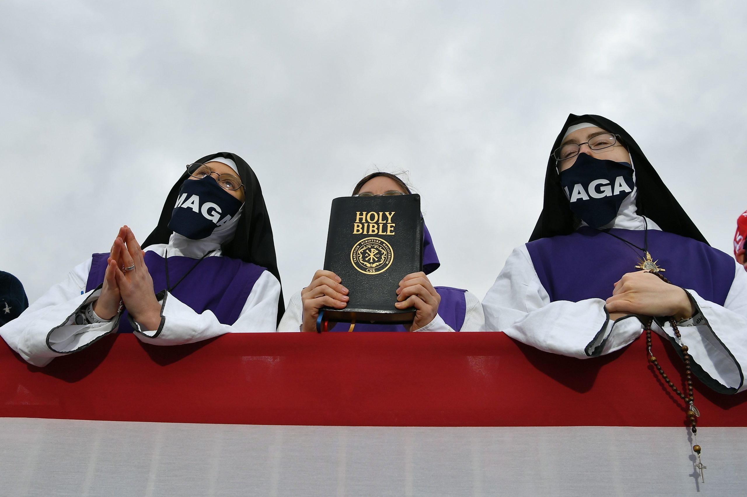 Nuns wearing masks displaying Trump's MAGA slogan listen as US President Donald Trump speaks during a campaign rally at Pickaway Agriculture and Event Center in Circleville, Ohio on October 24, 2020. (MANDEL NGAN/AFP via Getty Images)