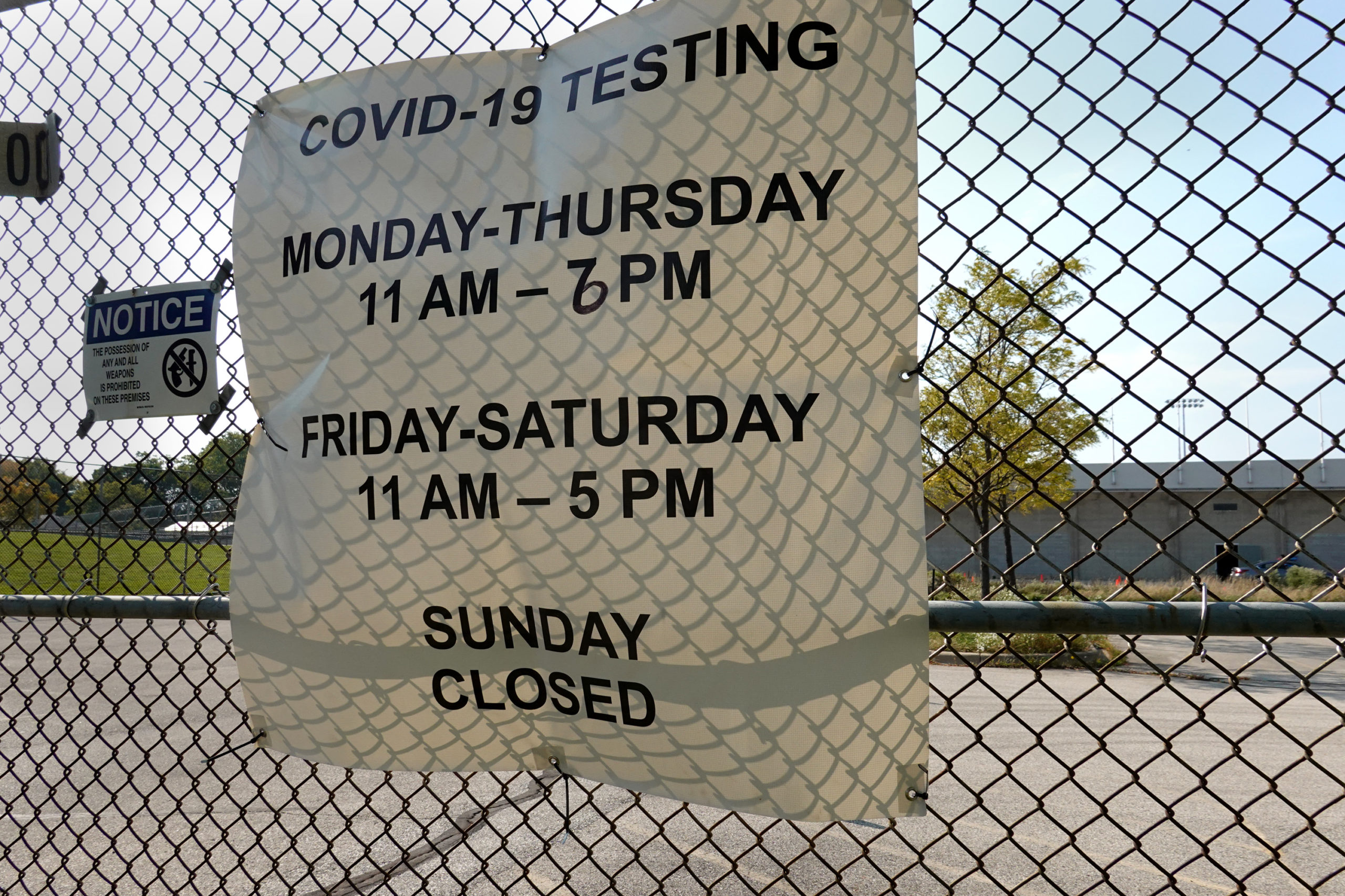 MILWAUKEE, WISCONSIN - OCTOBER 09: A sign hangs on a fence surrounding a temporary test site set up to test for the coronavirus COVID-19 at Barack Obama School on October 09, 2020 in Milwaukee, Wisconsin. Wisconsin currently has one of the highest positivity rates for COVID-19 in the nation. (Photo by Scott Olson/Getty Images)