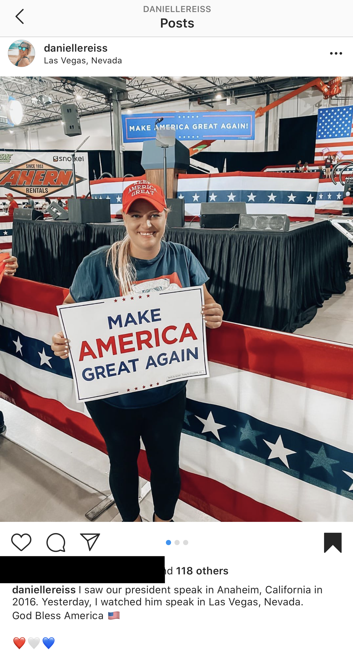 Danielle Reiss attended a Sept. 13 rally for President Donald Trump. She is holding a 'Make America Great Again' poster while wearing a red 'Make America Great Again' hat. Reiss was allegedly fired for the post. (Screenshot/Instagram)