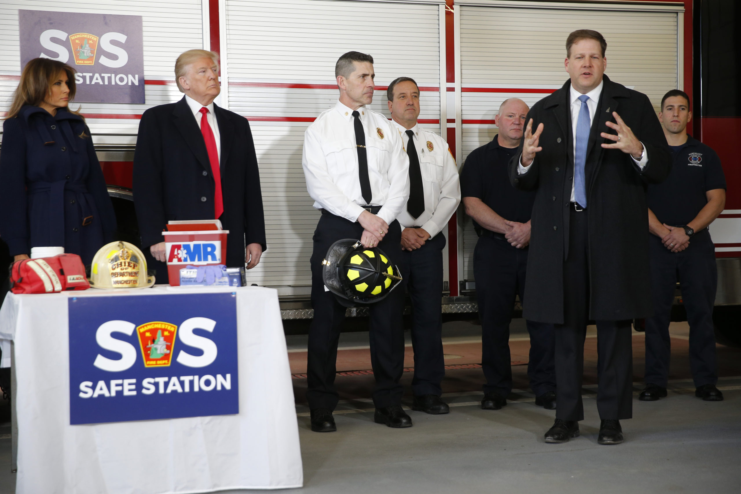 U.S. President Donald Trump listens to New Hampshire Governor Chris Sununu (R) as the president and first lady Melania Trump visit first responders who administer a drug treatment intake program at their fire station in Manchester, New Hampshire, U.S. March 19, 2018. REUTERS/Jonathan Ernst