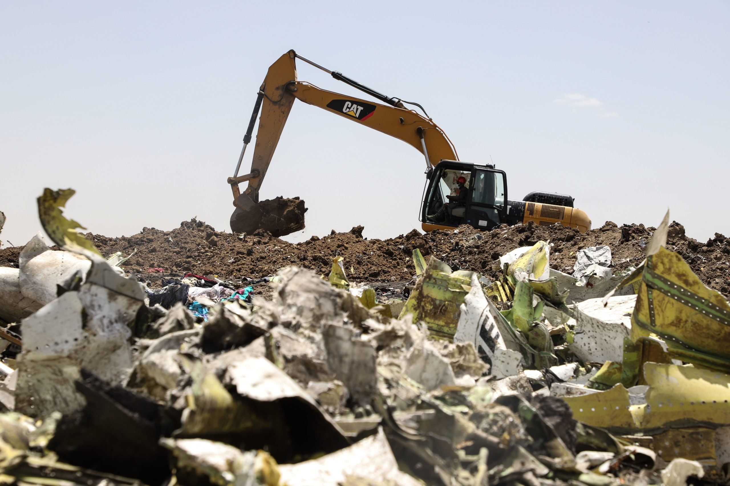 A power shovel digs at the crash site of Ethiopia Airlines near Bishoftu, a town some 60 kilometres southeast of Addis Ababa, Ethiopia, on March 11, 2019. - Airlines in Ethiopia, China and Indonesia grounded Boeing 737 MAX 8 jets Monday as investigators recovered the black boxes from a brand-new passenger jet that crashed outside Addis Ababa a day earlier, killing all 157 people on board. (Photo by Michael TEWELDE / AFP) (Photo credit should read MICHAEL TEWELDE/AFP via Getty Images)