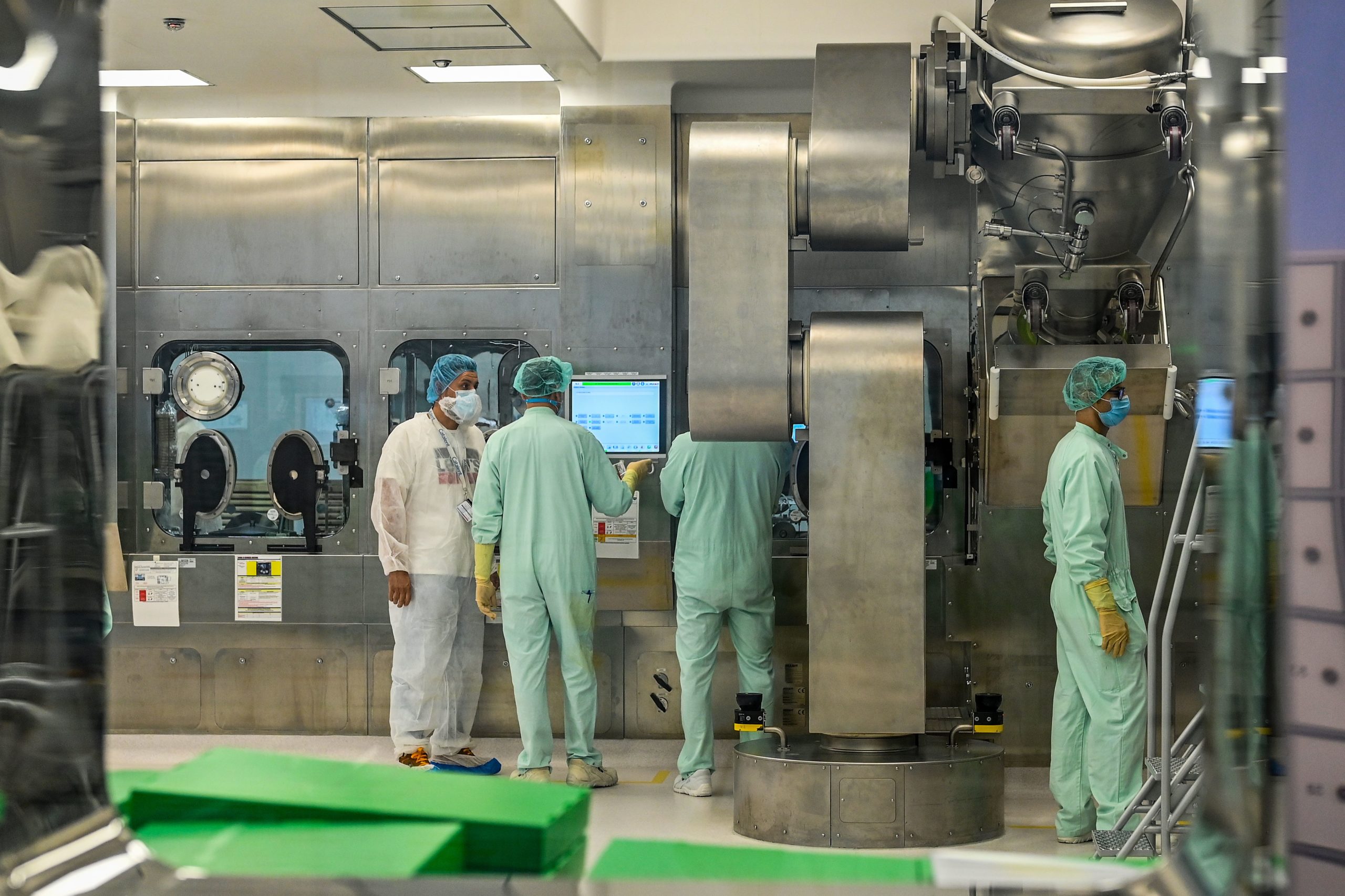 Laboratory technicians supervise filling and packaging tests for the large-scale production and supply of the University of Oxfords COVID-19 vaccine candidate, AZD1222, conducted on a high-performance aseptic vial filling line on September 11, 2020 at the Italian biologics manufacturing facility of multinational corporation Catalent in Anagni, southeast of Rome, during the COVID-19 infection, caused by the novel coronavirus. - Catalent Biologics manufacturing facility in Anagni, Italy will serve as the launch facility for the large-scale production and supply of the University of Oxfords Covid-19 vaccine candidate, AZD1222, providing large-scale vial filling and packaging to British-Swedish multinational pharmaceutical and biopharmaceutical company AstraZeneca. (Photo by Vincenzo PINTO / AFP) (Photo by VINCENZO PINTO/AFP via Getty Images)
