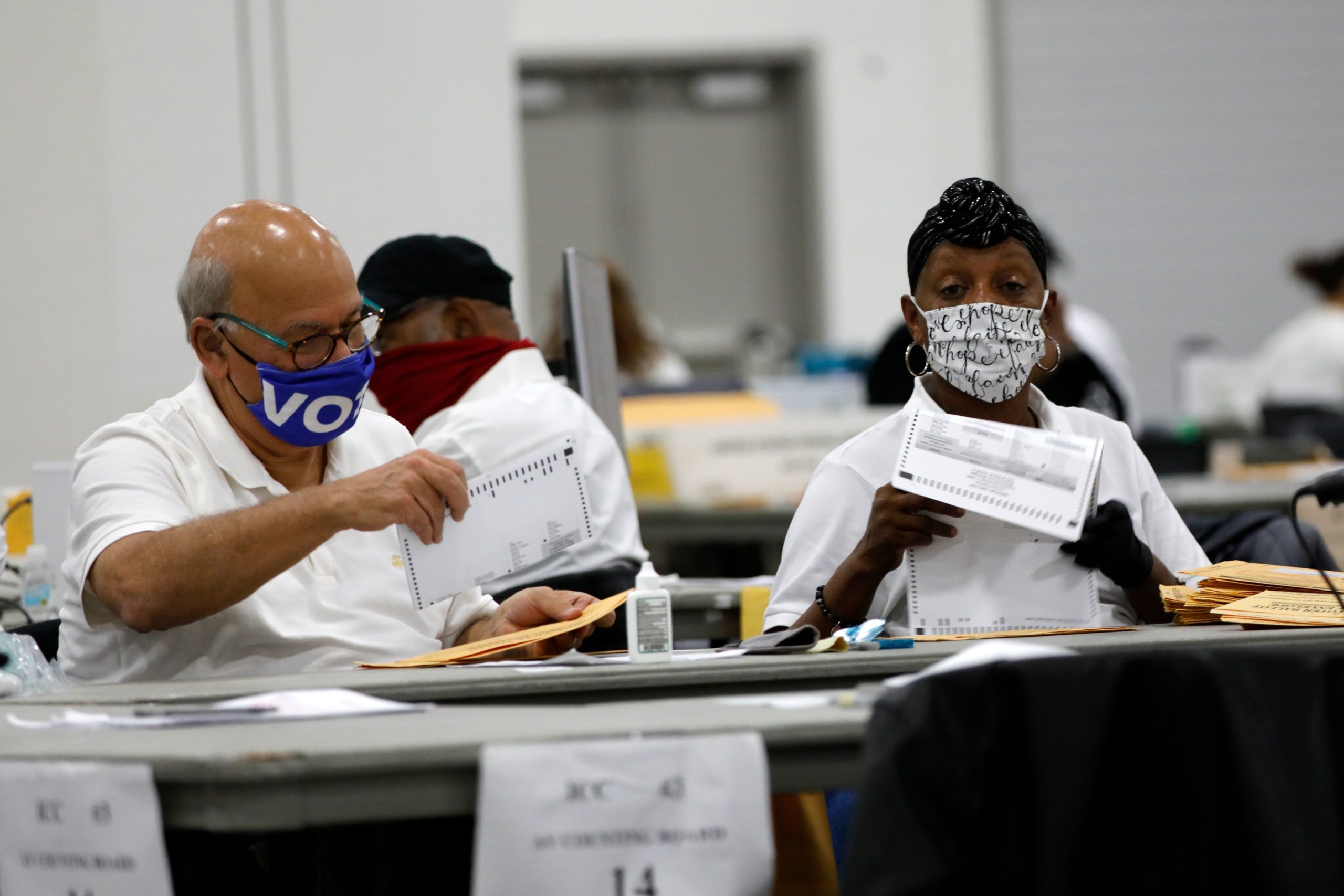 Detroit election workers work on counting absentee ballots for the 2020 general election early Wednesday in Detroit, Michigan. (Jeff Kowalsky/AFP via Getty Images)
