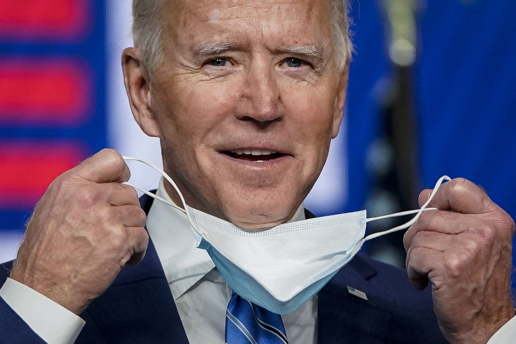 Democratic presidential nominee Joe Biden takes his face mask off as he arrives to speak one day after America voted in the presidential election, on Nov. 4 Wilmington, Delaware. (Drew Angerer/Getty Images)