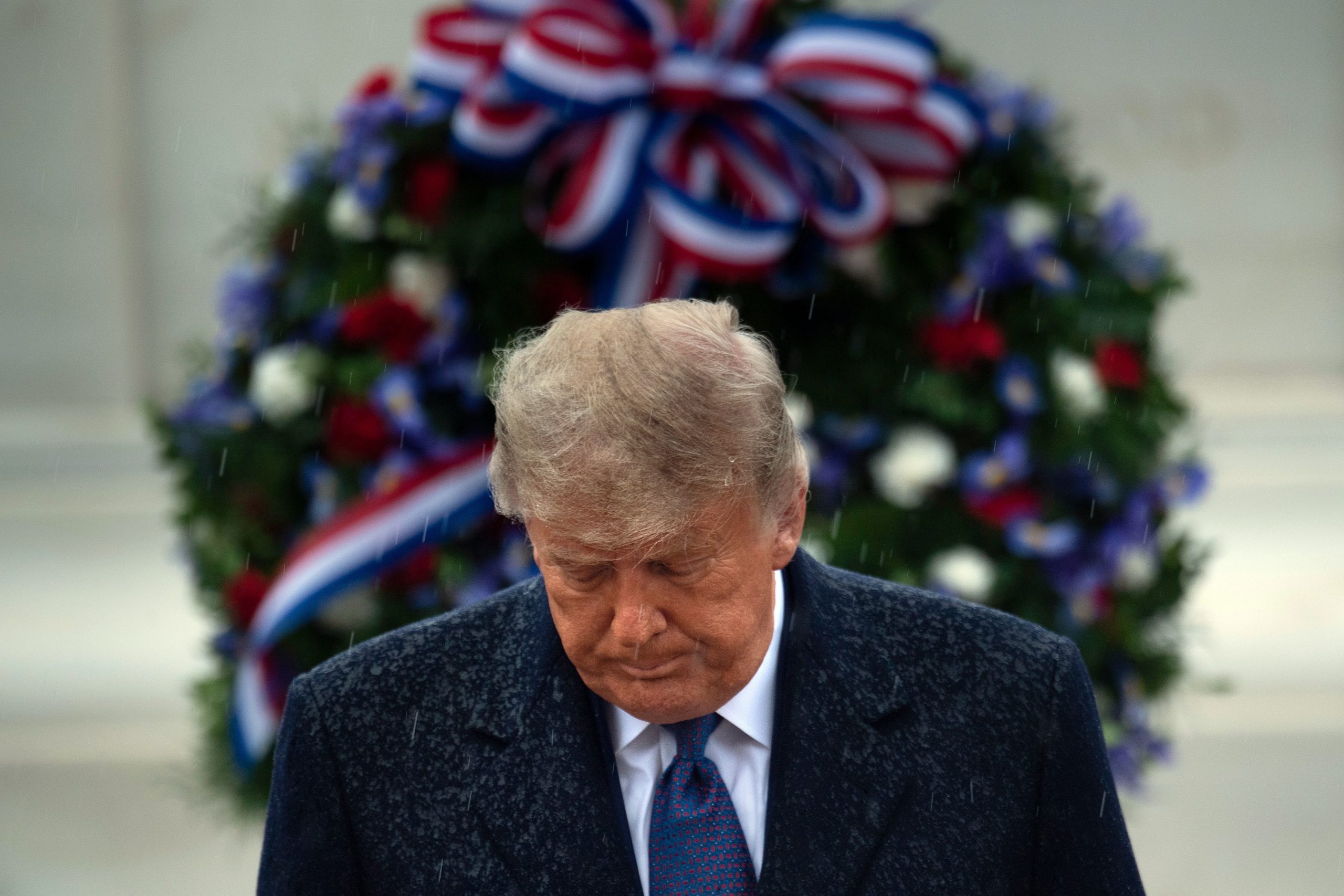 US President Donald Trump leaves after placing a wreath at the Tomb of the Unknown Soldier on Veterans Day at Arlington National Cemetery in Arlington, Virginia, on November 11, 2020. - US President Donald Trump made his first official post-election appearance Wednesday for what should be a moment of national unity to mark Veteran's Day, now marred by his refusal to acknowledge Joe Biden's win. The president visited Arlington National Cemetery, four days after US media projected his Democratic rival would take the White House. (Photo by BRENDAN SMIALOWSKI/AFP via Getty Images)