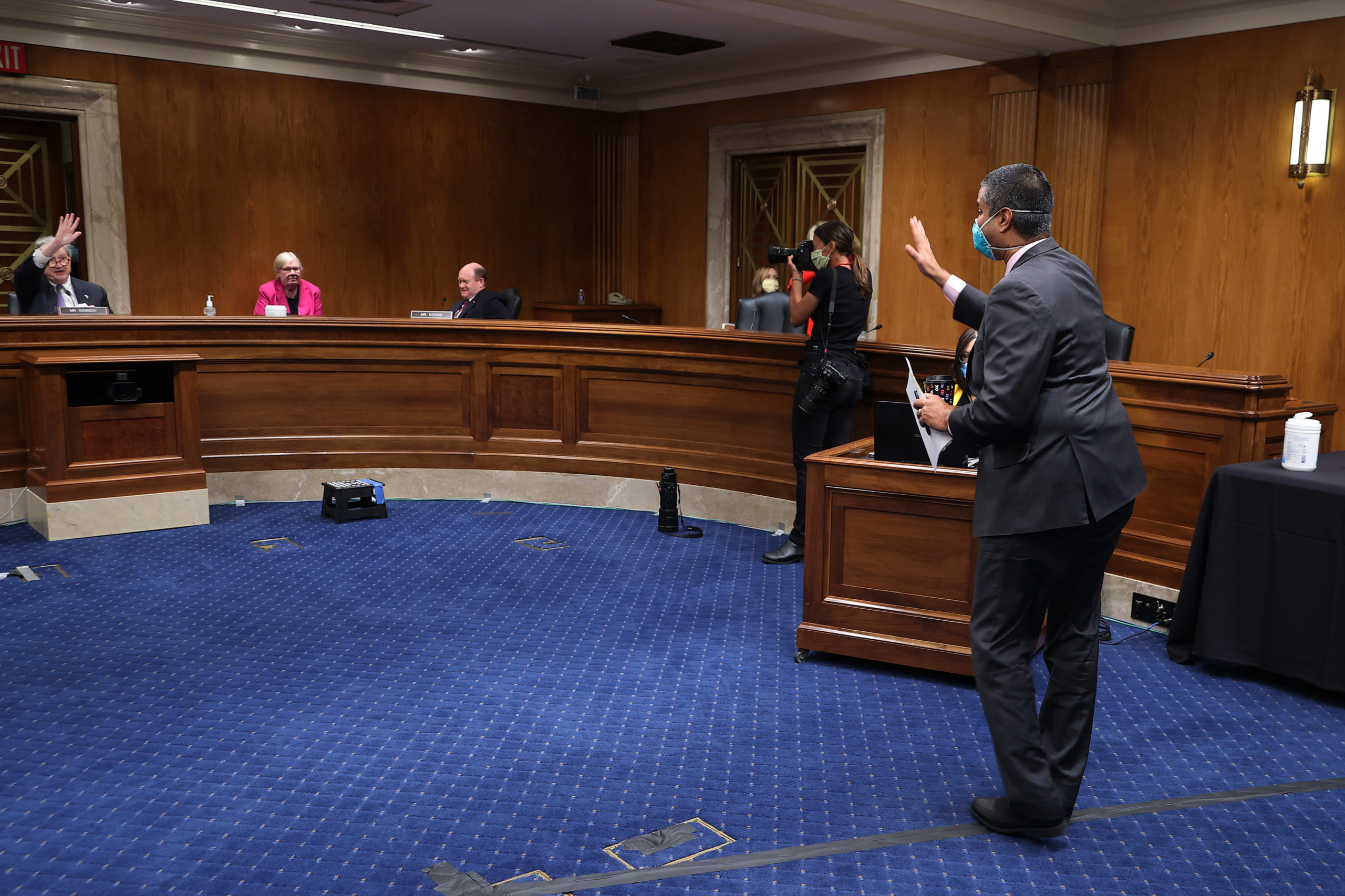FCC Chairman Ajit Pai waves goodbye to members of a Senate Appropriations Subcommittee afters testifying during a hearing on Capitol Hill in June. (Chip Somodevilla/Getty Images)
