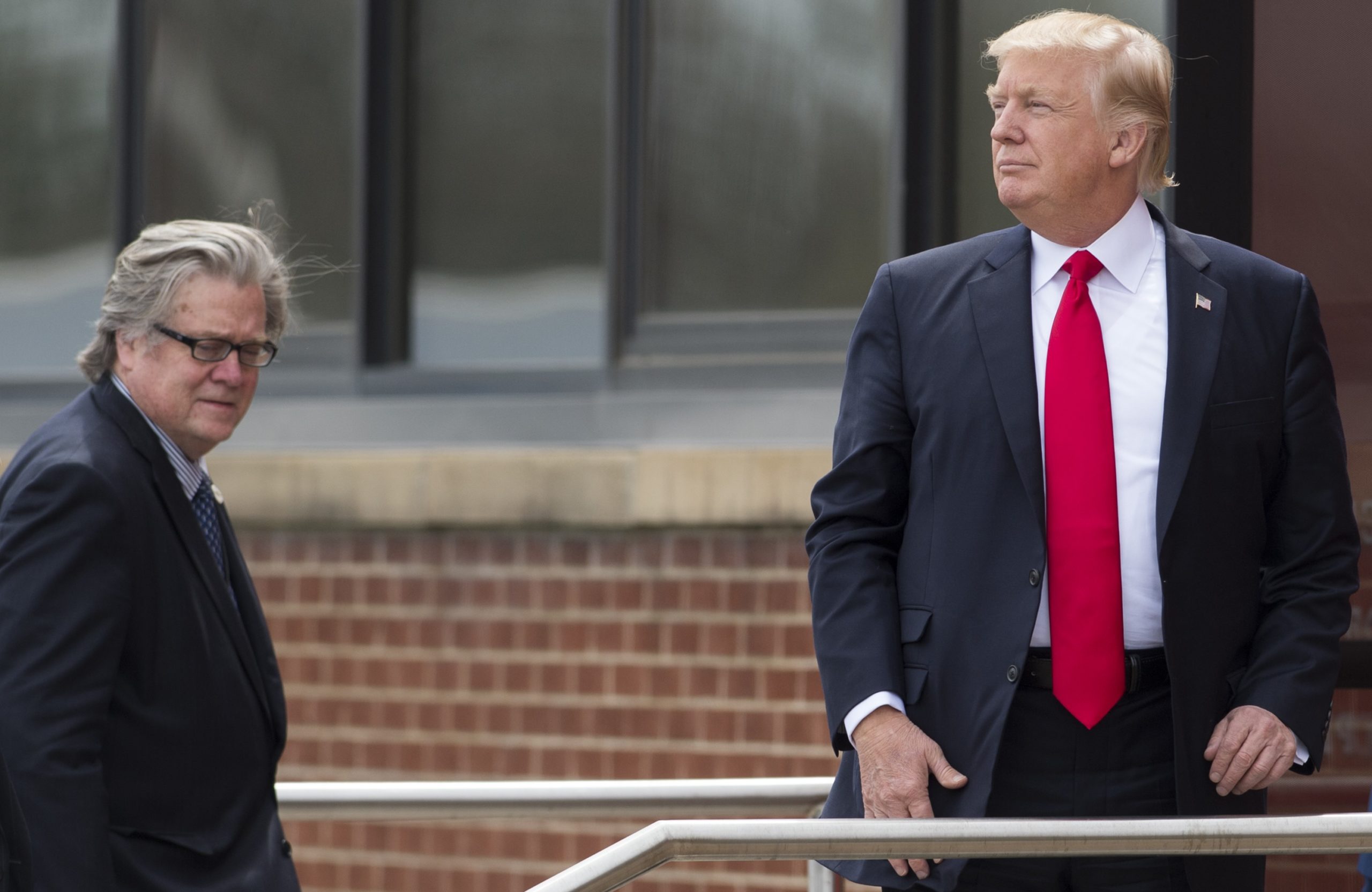 US President Donald Trump stands alongside Chief Strategist Stephen Bannon (L) upon arrival at Snap-On Tools in Kenosha, Wisconsin, April 18, 2017, prior to signing the Buy American, Hire American Executive Order. (SAUL LOEB/AFP via Getty Images)
