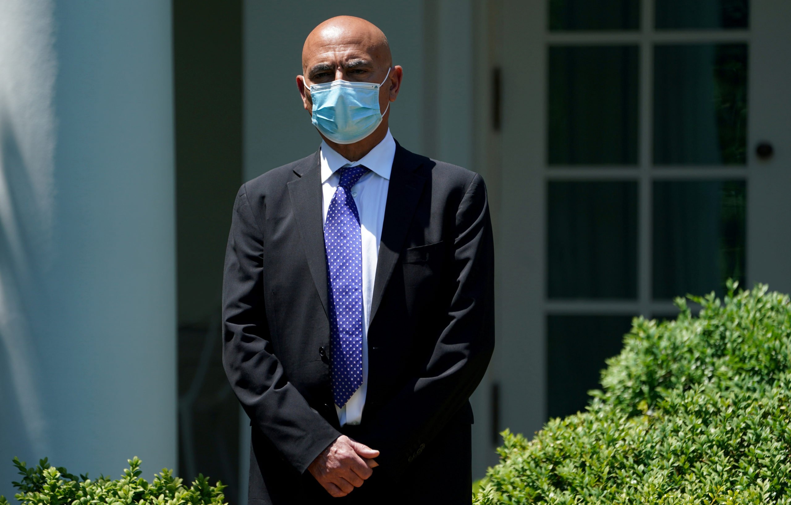  Former GlaxoSmithKline pharmaceutical executive Moncef Slaoui, who will serve as chief adviser on the effort to find a vaccine for the coronavirus disease (COVID-19) pandemic, waits to speak as President Donald Trump holds a coronavirus disease response event in the Rose Garden at the White House in Washington, U.S., May 15, 2020. REUTERS/Kevin Lamarque/File Photo