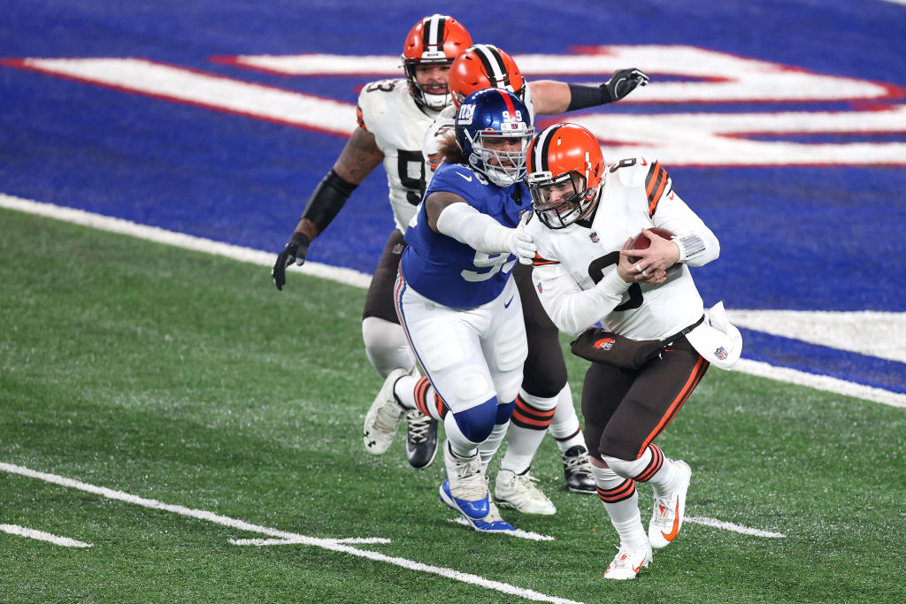 EAST RUTHERFORD, NEW JERSEY - DECEMBER 20: Baker Mayfield #6 of the Cleveland Browns scrambles from defender Leonard Williams #99 of the New York Giants during the third quarter of a game at MetLife Stadium on December 20, 2020 in East Rutherford, New Jersey. (Photo by Al Bello/Getty Images)