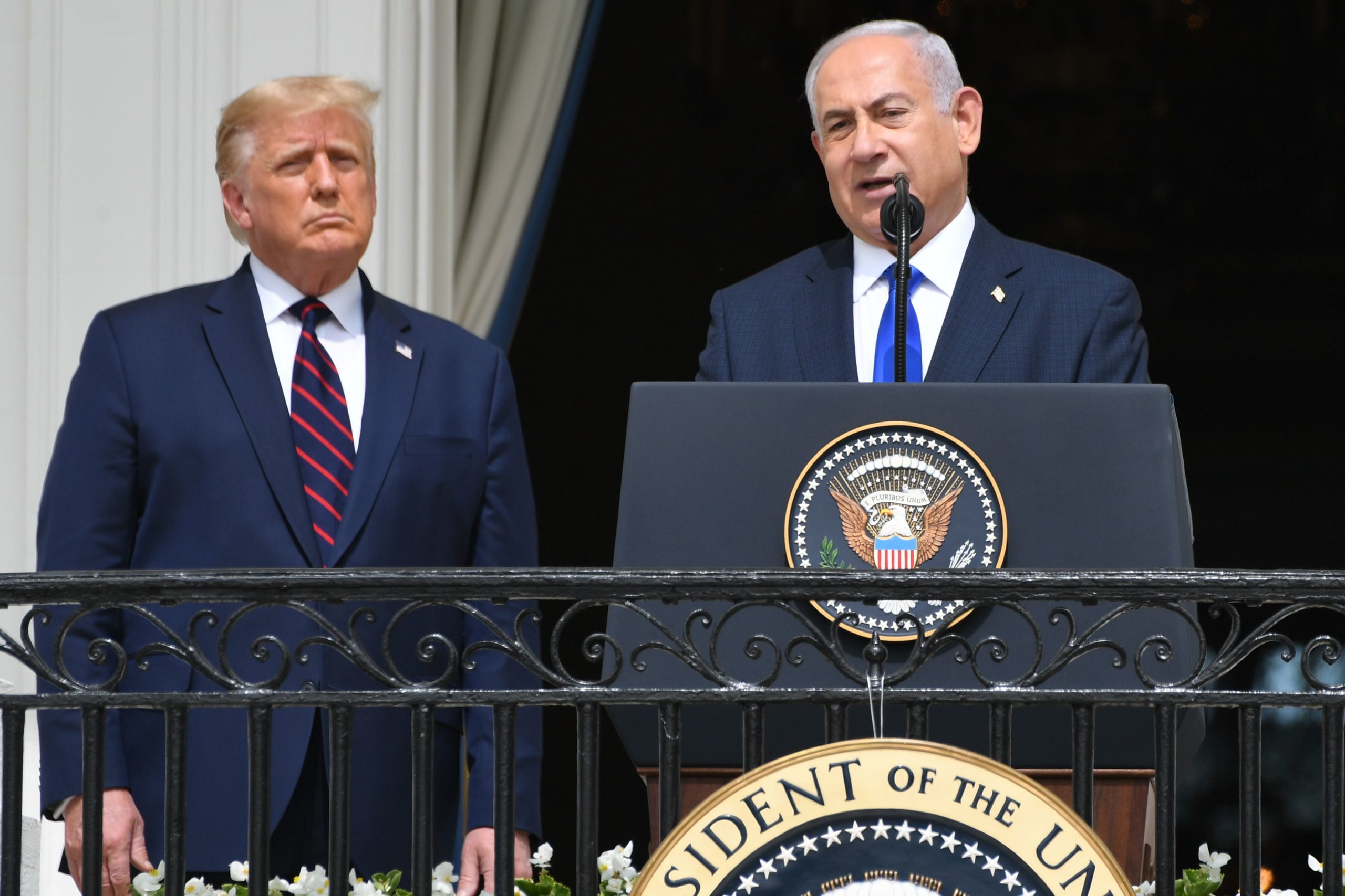 US President Donald Trump watches as Israeli Prime Minister Benjamin Netanyahu (R) speaks from the Truman Balcony at the White House during the signing ceremony of the Abraham Accords