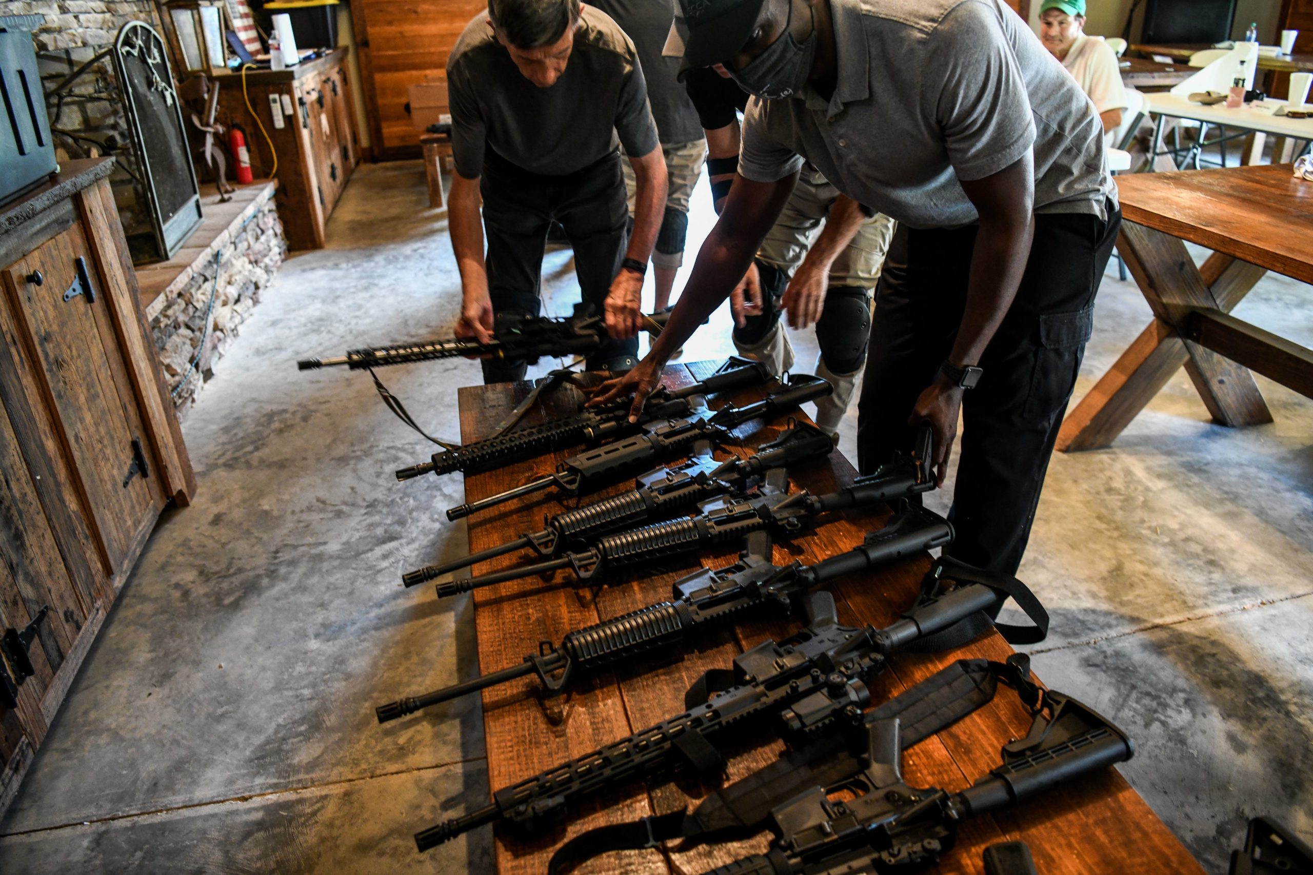 Students place their AR-15 semi-automatic rifles on a bench during a shooting course at Boondocks Firearms Academy in Jackson, Mississippi on September 26, 2020. - From the countryside to the cities, Americans are engaged in a frenzy of gun-buying fueled by the pandemic, protests and politics. (CHANDAN KHANNA/AFP via Getty Images)
