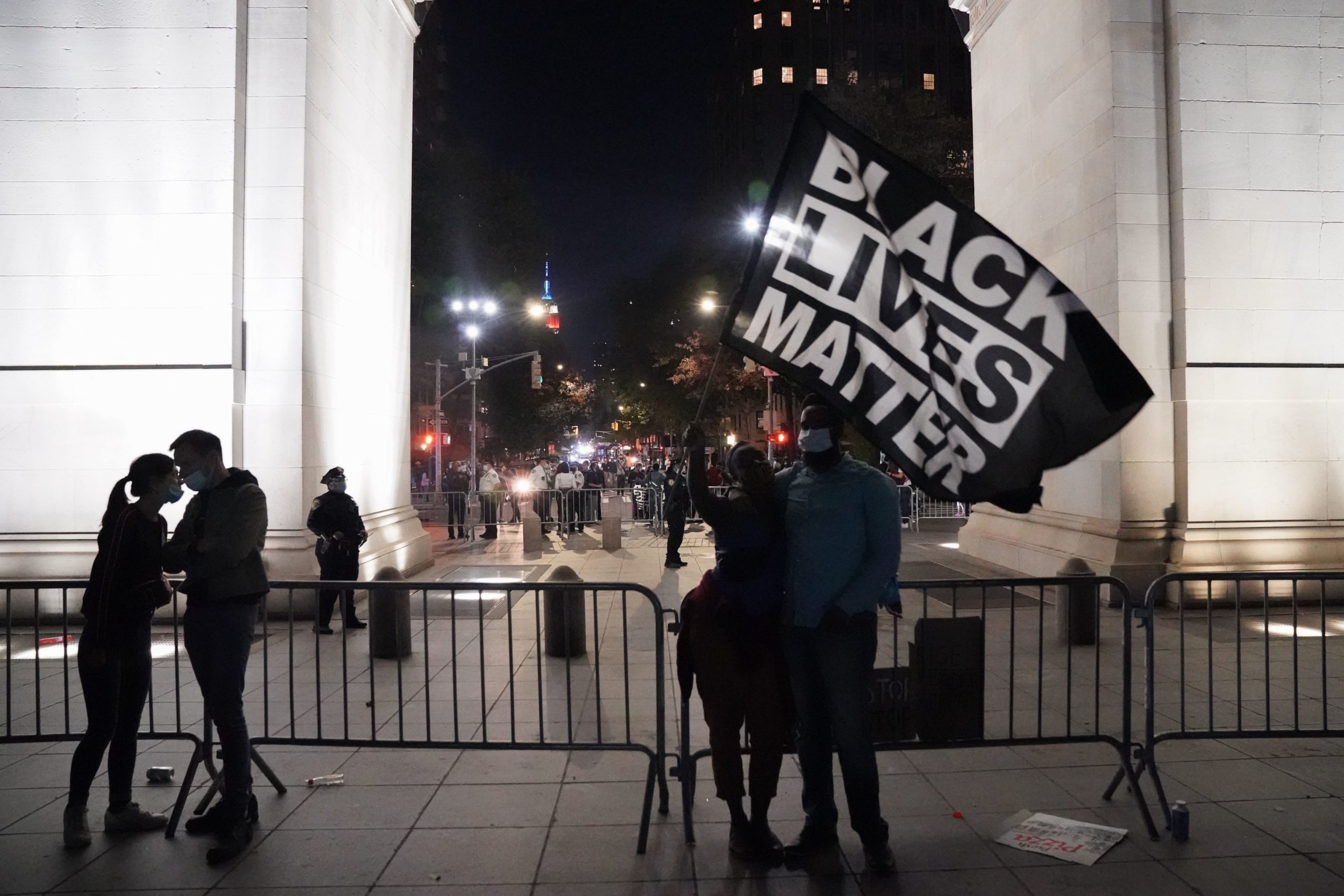 People hold a Black Lives Matter flag as they celebrate in Washington Square Park after Joe Biden was declared the next President on November 7, 2020 in New York. (BRYAN R. SMITH/AFP via Getty Images)