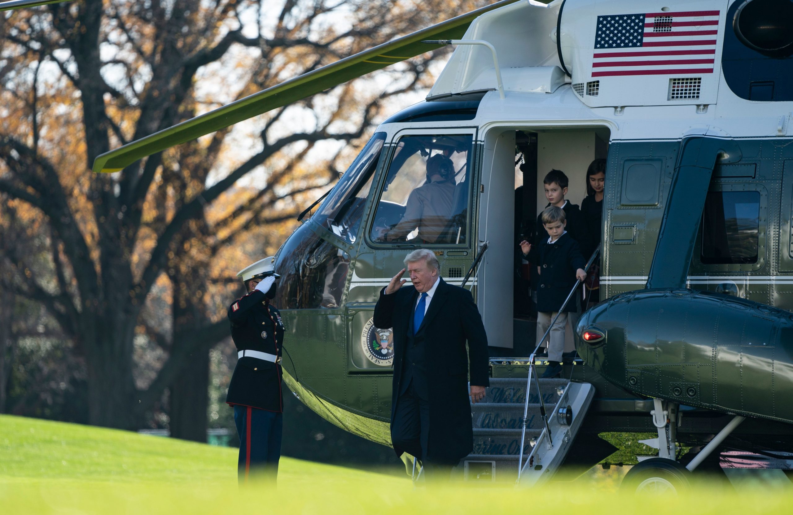 US President Donald Trump, followed by his grandchildren, Arabella, Theodore, and Joseph, arrives at the White House aboard Marine One on November 29, 2020 in Washington, DC. - President Trump spent the Thanksgiving weekend at Camp David and his Trump National Golf Course in Virginia. (Photo by ALEX EDELMAN/AFP via Getty Images)
