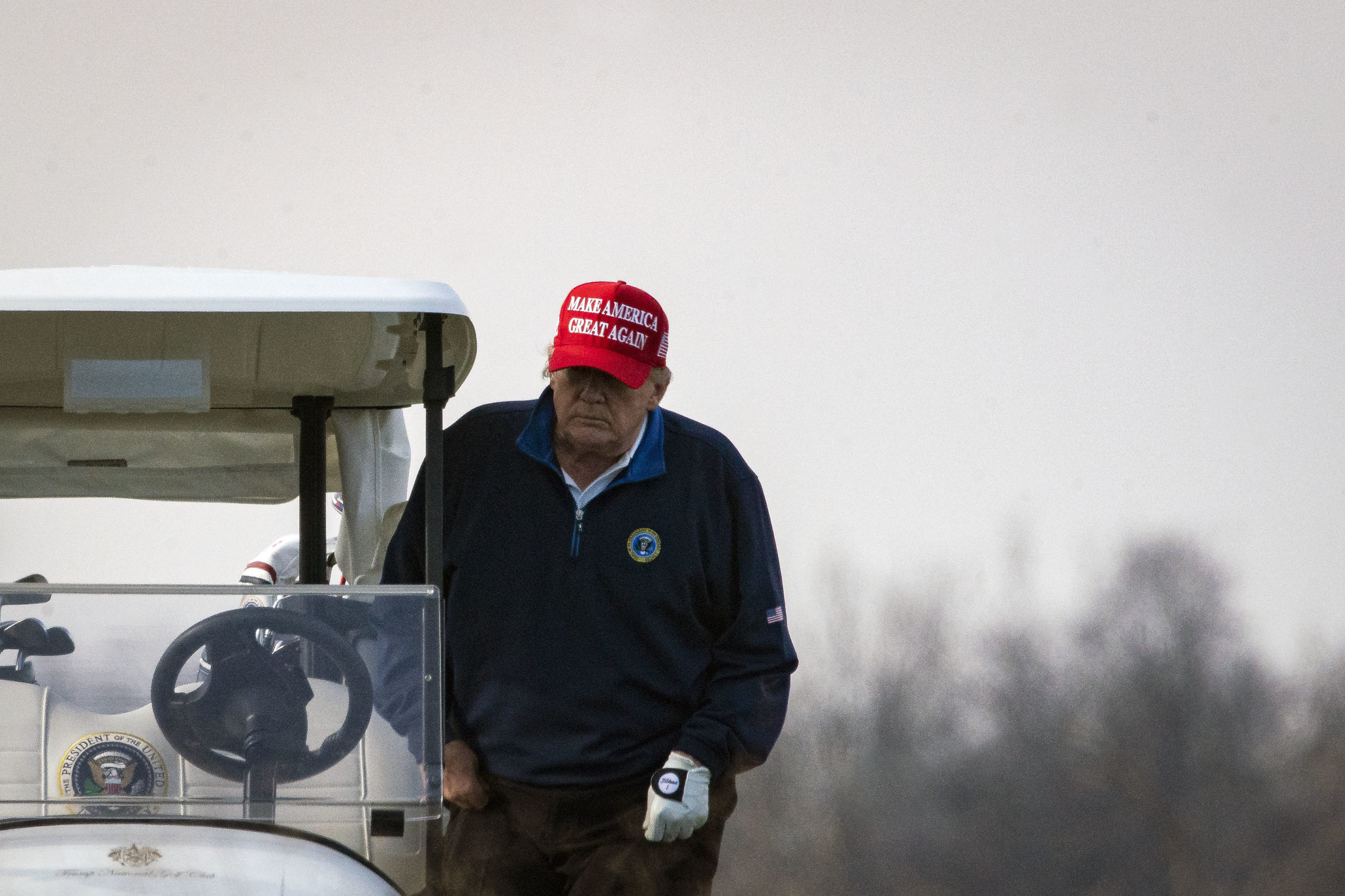 STERLING, VA - DECEMBER 13: U.S. President Donald Trump climbs into golf cart number 45 as he golfs at Trump National Golf Club on December 13, 2020 in Sterling, Virginia. (Photo by Al Drago/Getty Images)