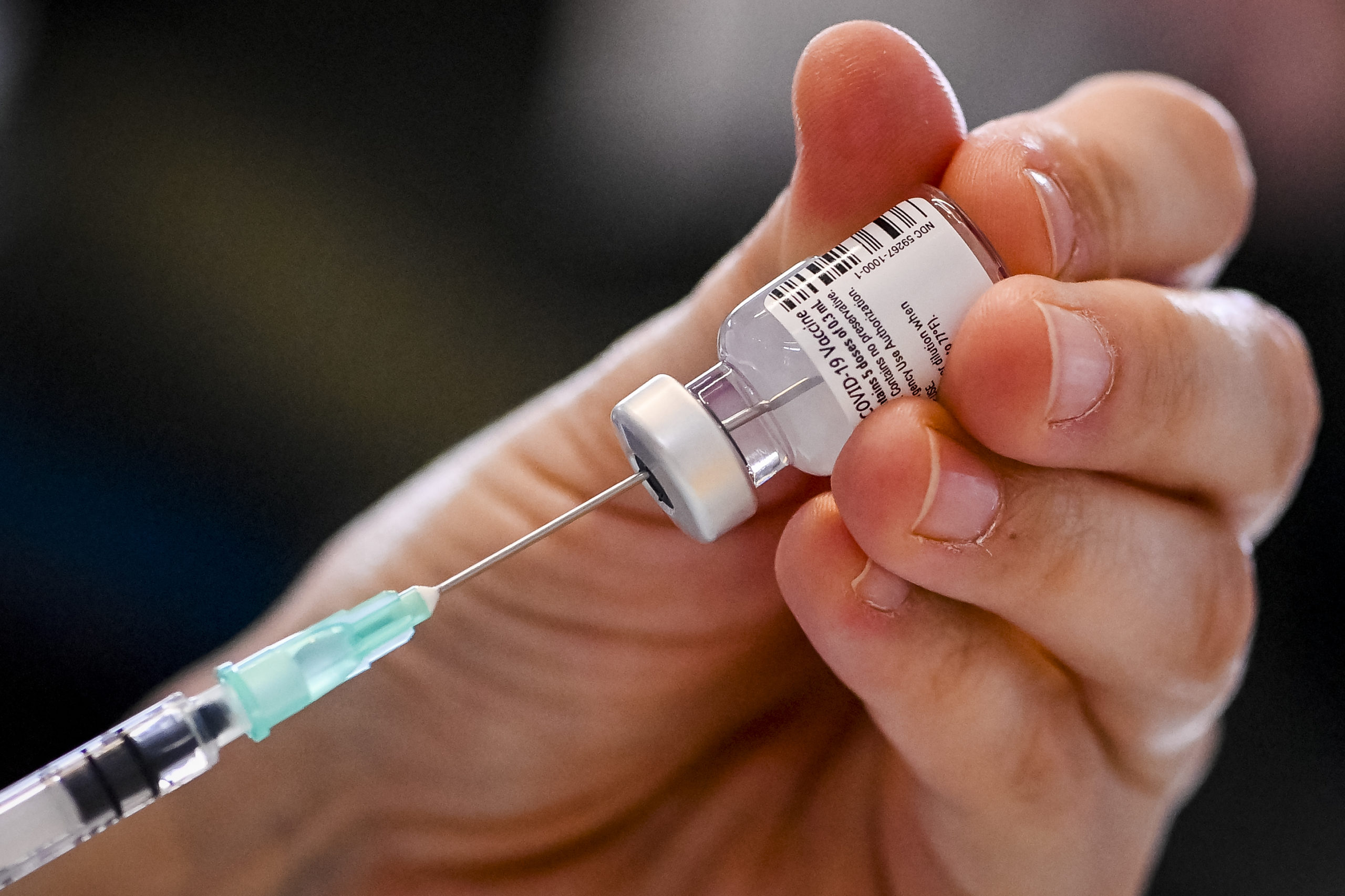 A nurse prepares a dose of the Pfizer-BioNTech Covid-19 vaccine, during a vaccination operation at the "Woonzorgcentrum Sint-Pieters" rest home on December 28, 2020 in Puurs, in Belgium's Flemish region, as the country starts its national vaccination campaign to fight against the spread of the novel coronavirus. (Photo by DIRK WAEM/POOL/AFP via Getty Images)