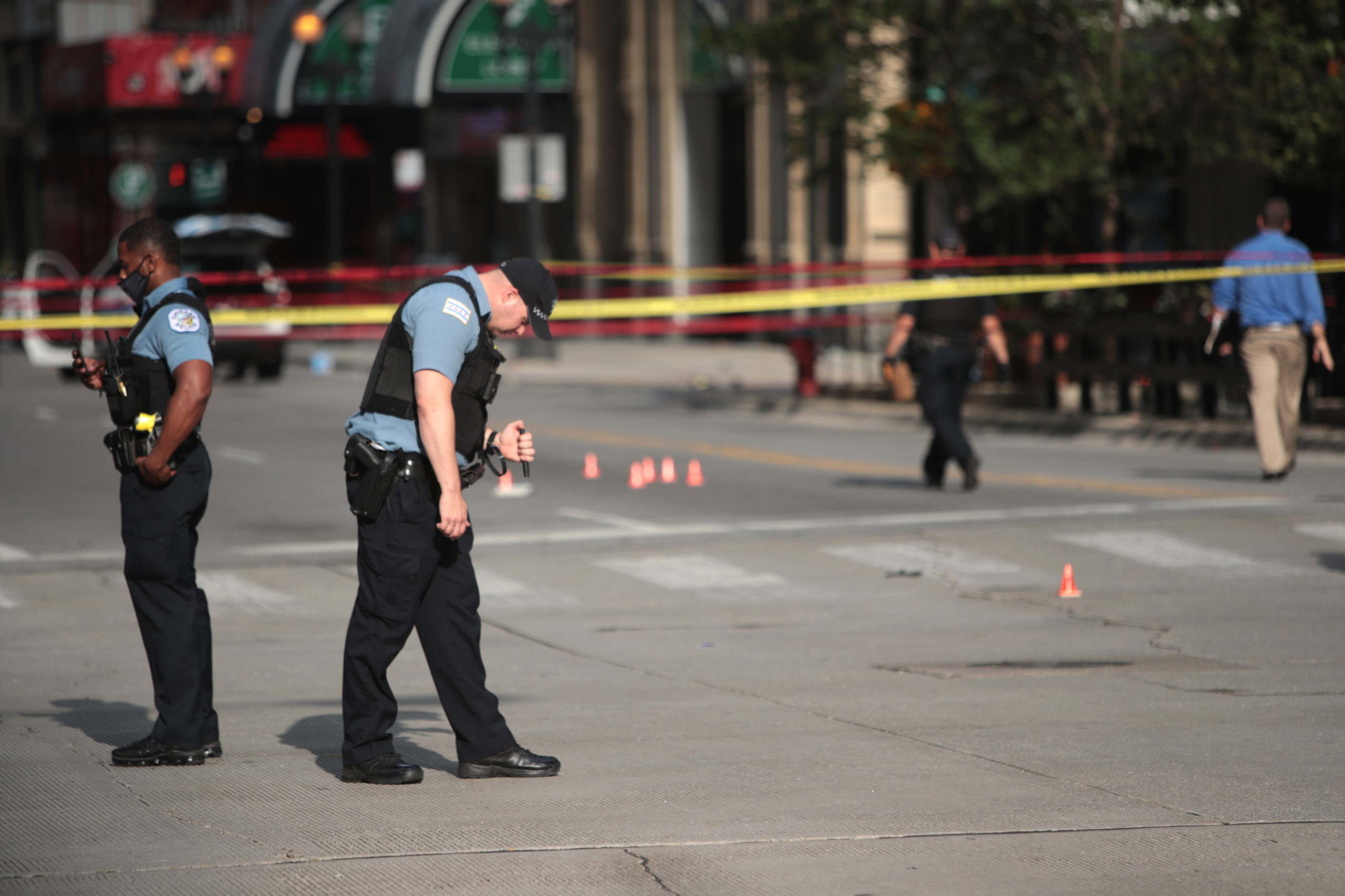 CHICAGO, ILLINOIS - AUGUST 10: Police investigate where a shooting took place on Michigan Ave. hours after the city suffered from widespread looting and vandalism, on August 10, 2020 in Chicago, Illinois. Police made several arrests during the night of unrest and recovered at least one firearm. (Scott Olson/Getty Images)