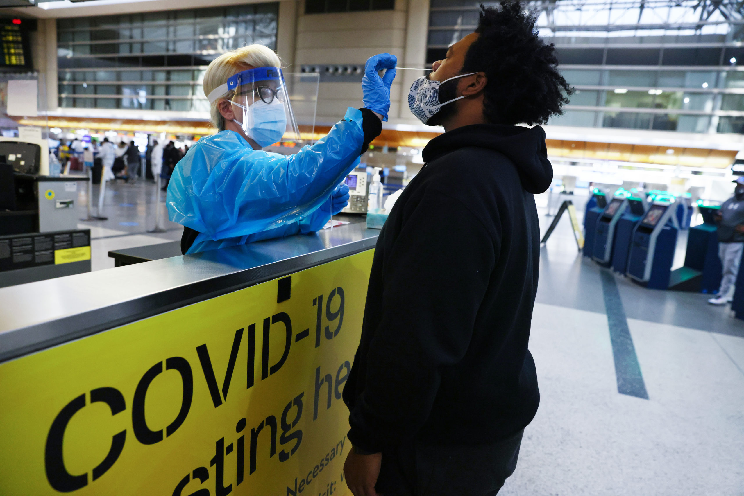 A man receives a nasal swab coronavirus test at Los Angeles International Airport amid a coronavirus surge in Southern California on Dec. 22 in Los Angeles, California. (Mario Tama/Getty Images)