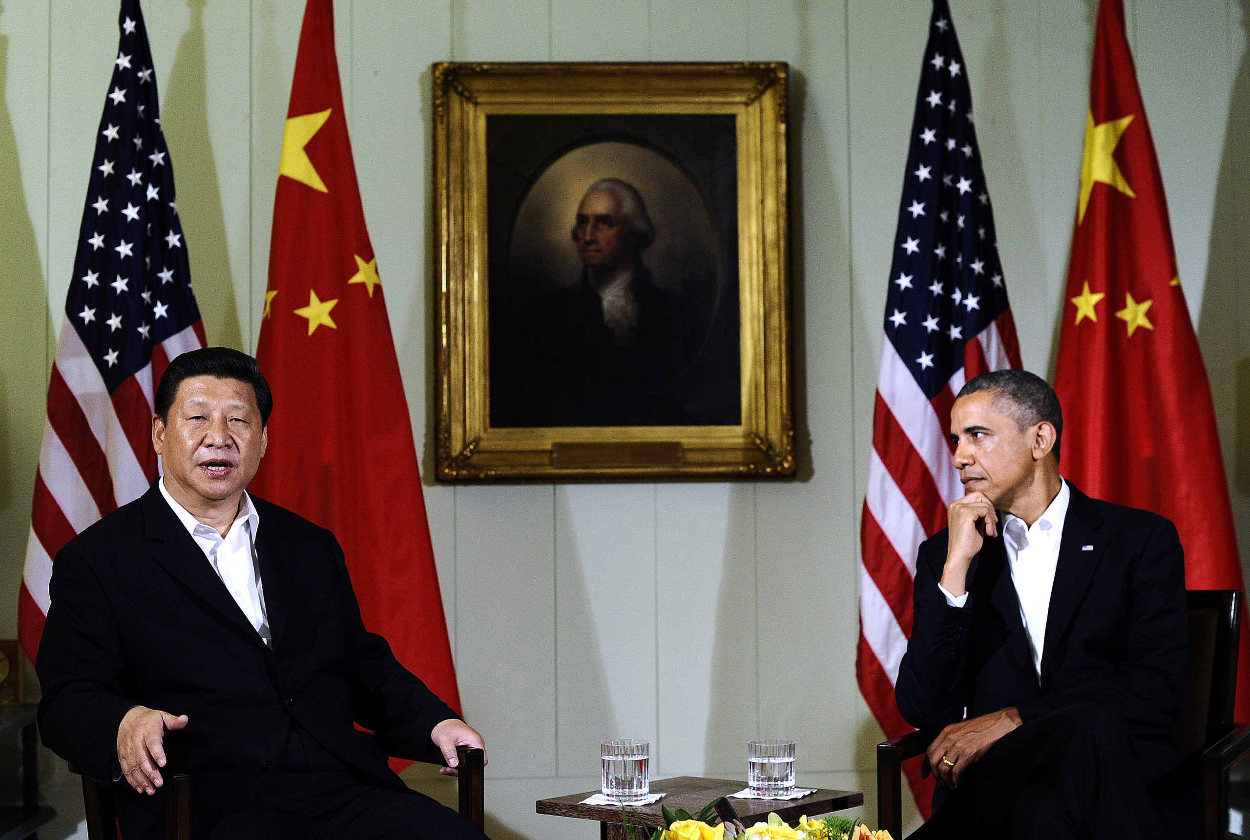 US President Barack Obama (R) listens as Chinese President Xi Jinping answers a question following their bilateral meeting at the Annenberg Retreat at Sunnylands in Rancho Mirage, California, on June 7, 2013.Obama, with Chinese counterpart Xi Jinping by his side, called Friday for common rules on cybersecurity after allegations of hacking by Beijing. At a summit in the Calfornia desert, Obama said it was "critical" to reach a "permanent understanding" on cybersecurity. He also voiced concern over intellectual theft and urged "common rules of the road." (Photo by Jewel Samad/AFP via Getty Images)