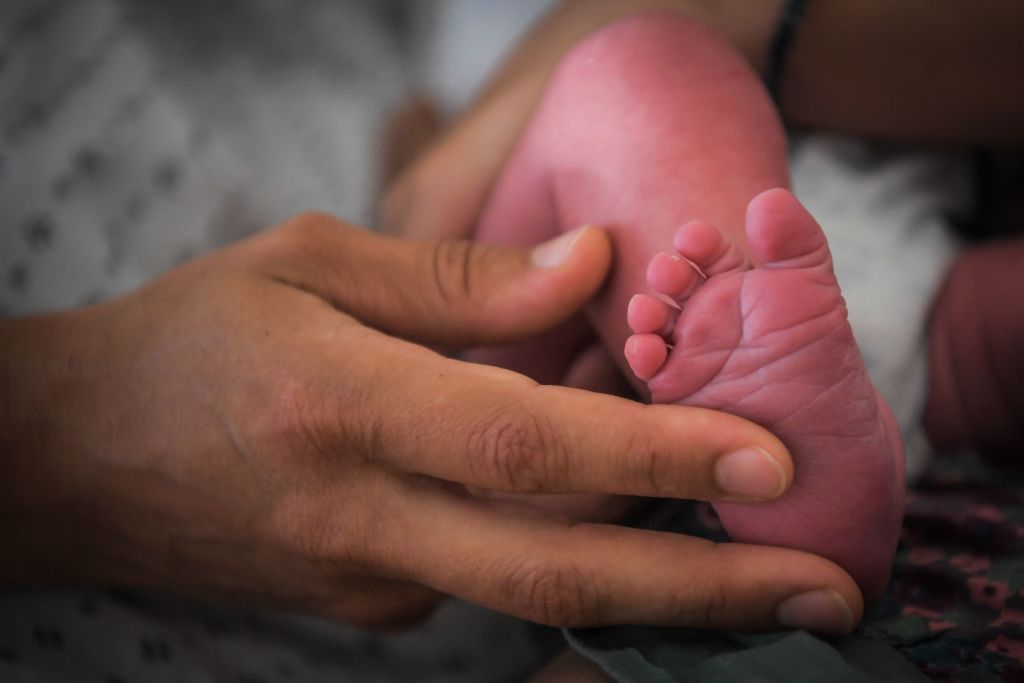 Mother Holds Newborn's Foot In Hospital