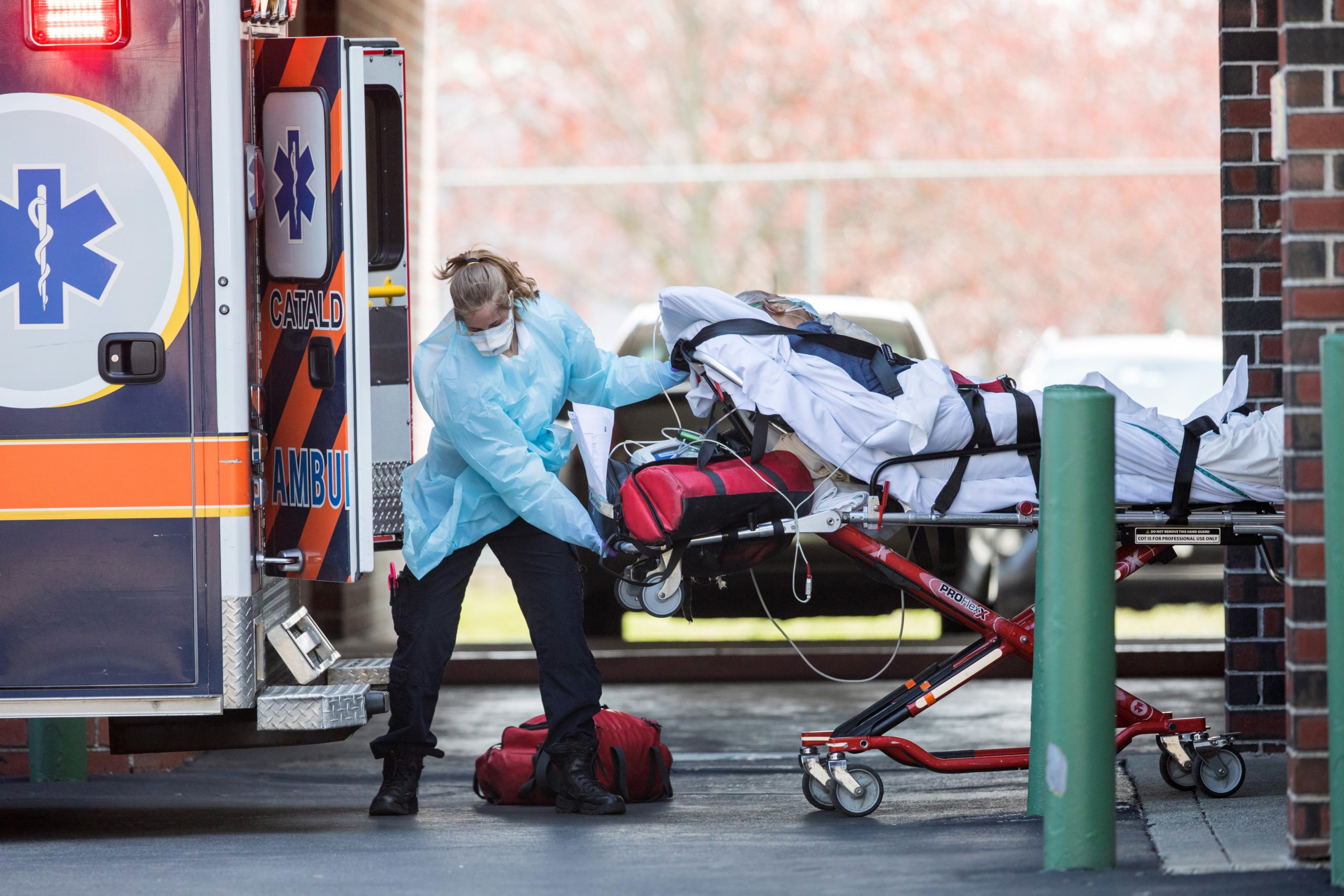 First responders load a patient into an ambulance from a nursing home where multiple people have contracted COID-19 on April 17, 2020 in Chelsea, Massachusetts. (Photo by Scott Eisen/Getty Images)