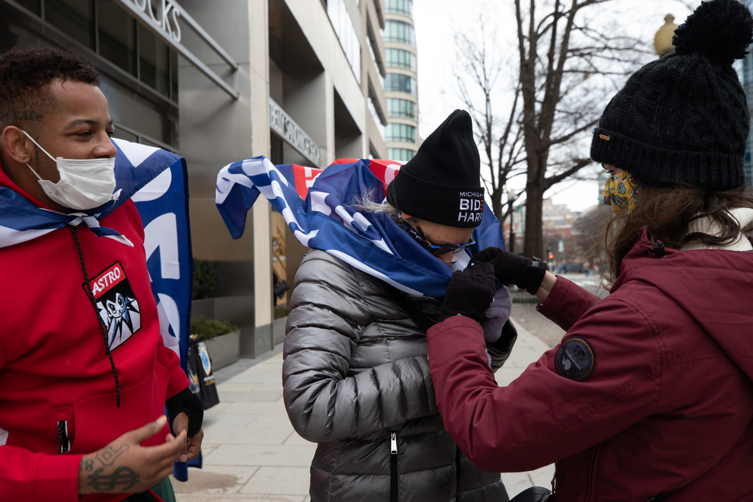 A woman tied a Biden-Harris flag around her neck in Washington, D.C. on Jan. 20, 2021. (Kaylee Greenlee - Daily Caller News Foundation)