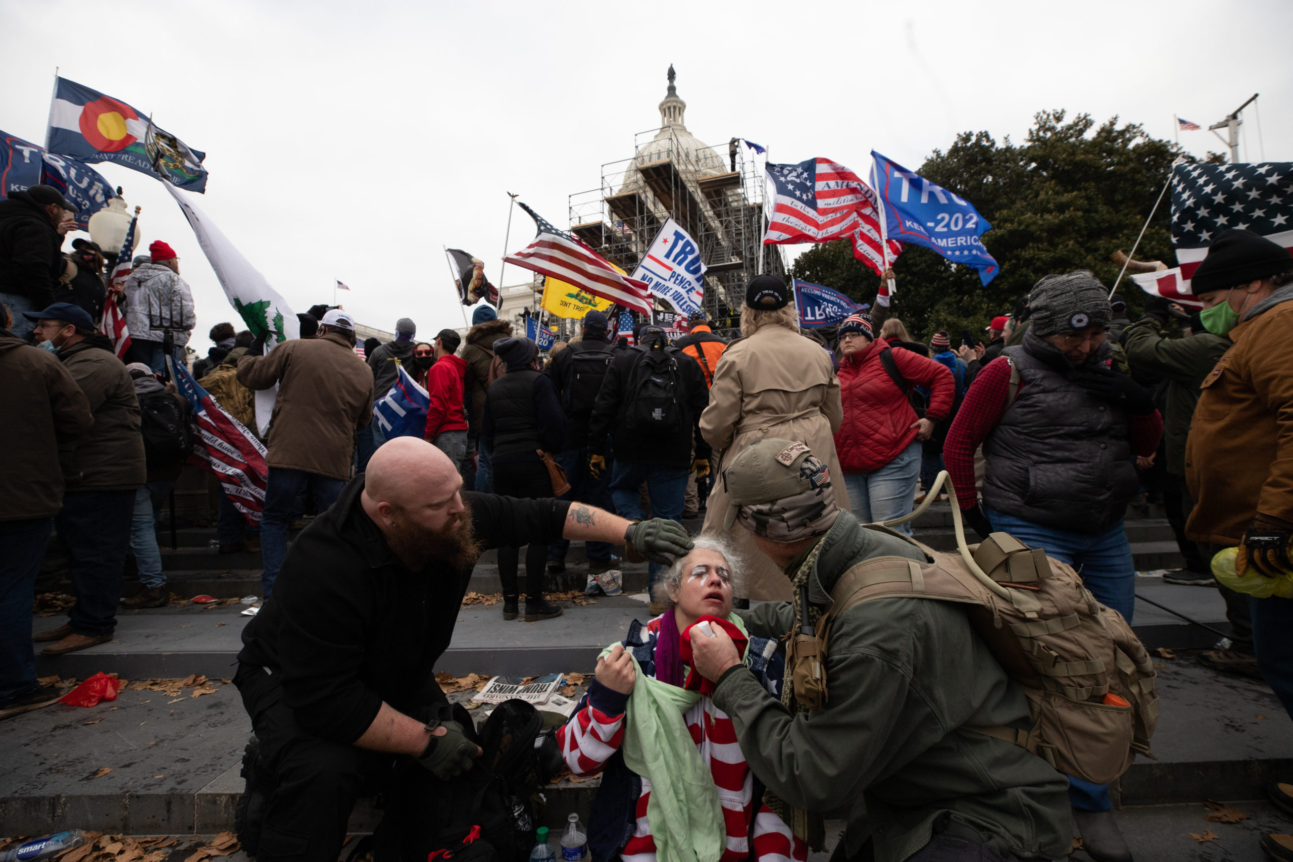 A woman was treated after being exposed to tear gas on the steps of the Capitol Building on January 6, 2021, in Washington, D.C. Supporters of former President Donald Trump stormed the Capitol Building in an effort to stop the Congressional certification of President Joe Biden. (Kaylee Greenlee - DCNF)