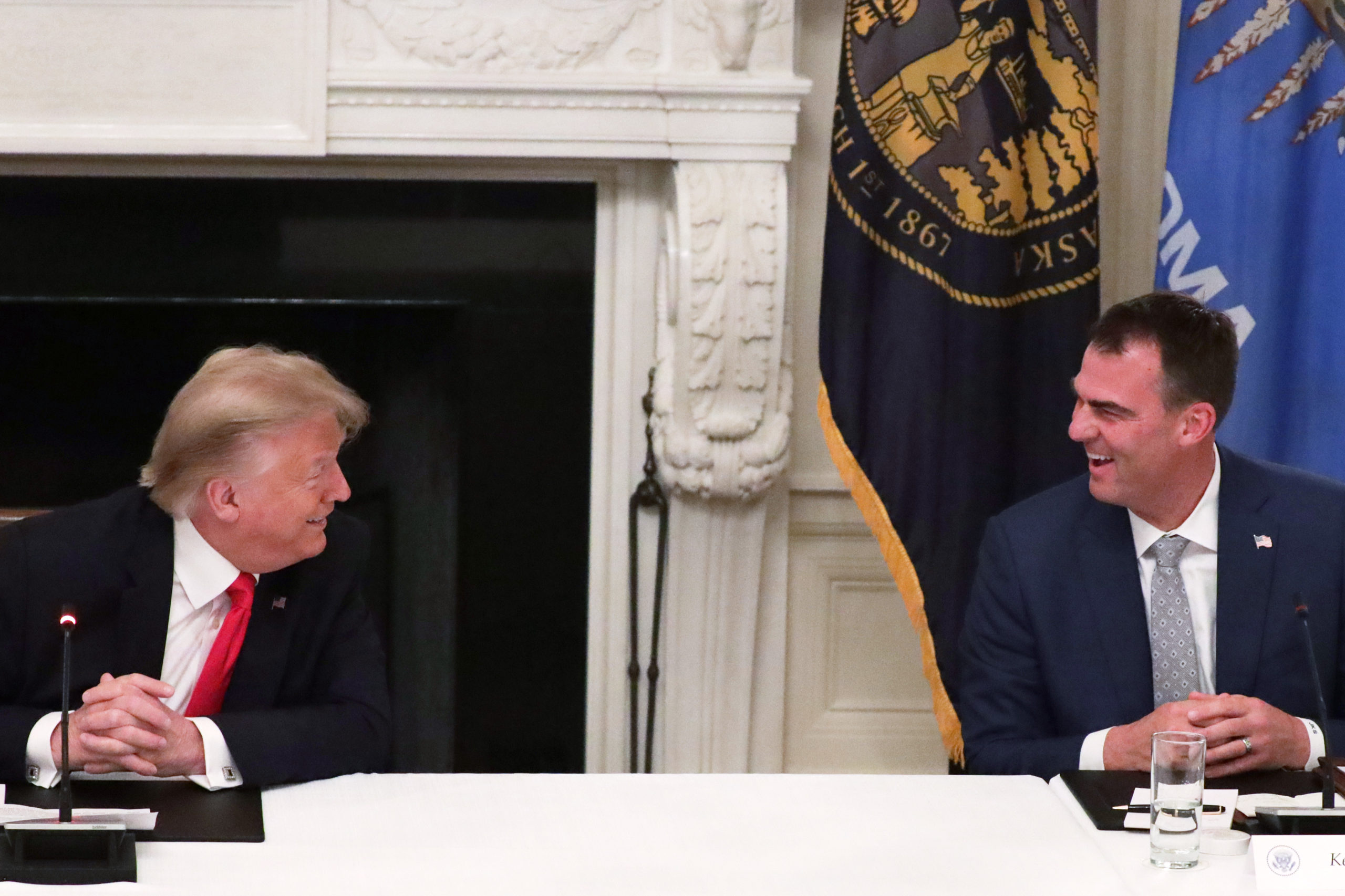 WASHINGTON, DC - JUNE 18: U.S. President Donald Trump listens as Governor Kevin Stitt (R-OK) speaks during a roundtable at the State Dining Room of the White House June 18, 2020 in Washington, DC. President Trump held a roundtable discussion with Governors and small business owners on the reopening of American’s small business. (Photo by Alex Wong/Getty Images)