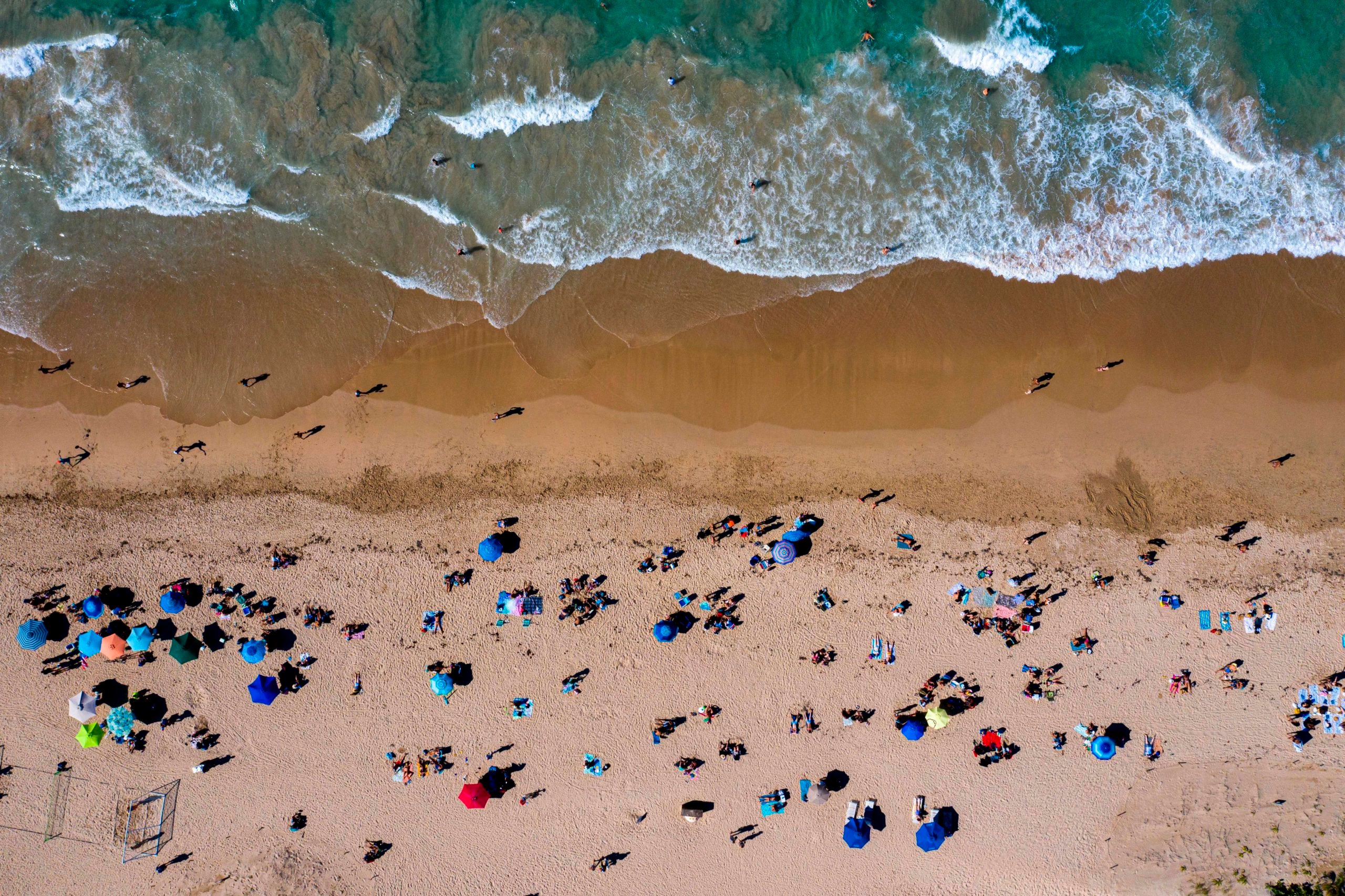 People are seen on the beach in San Juan Puerto Rico on March 15, 2020. (Ricardo Arduengo/AFP via Getty Images)