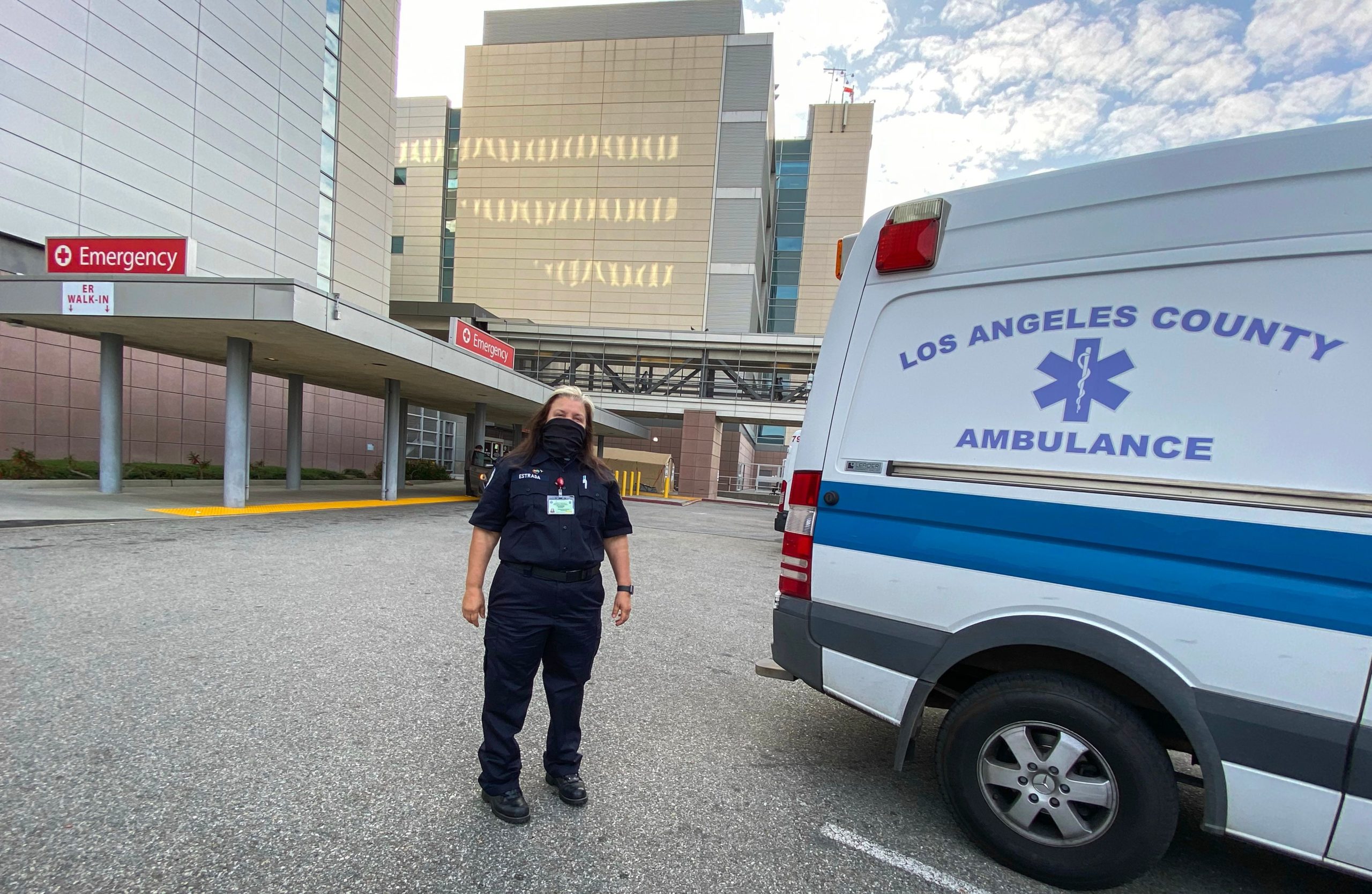 Emergency Medical Technician (EMT), Yvonne Estrada walks back to her ambulance parked in front of LAC+USC Medical Center, April 20, 2020, in Los Angeles, California. - Estrada works everyday on the front line during the Covid 19 crisis, transporting patients to the Hospital. (Photo by VALERIE MACON / AFP) (Photo by VALERIE MACON/AFP via Getty Images)