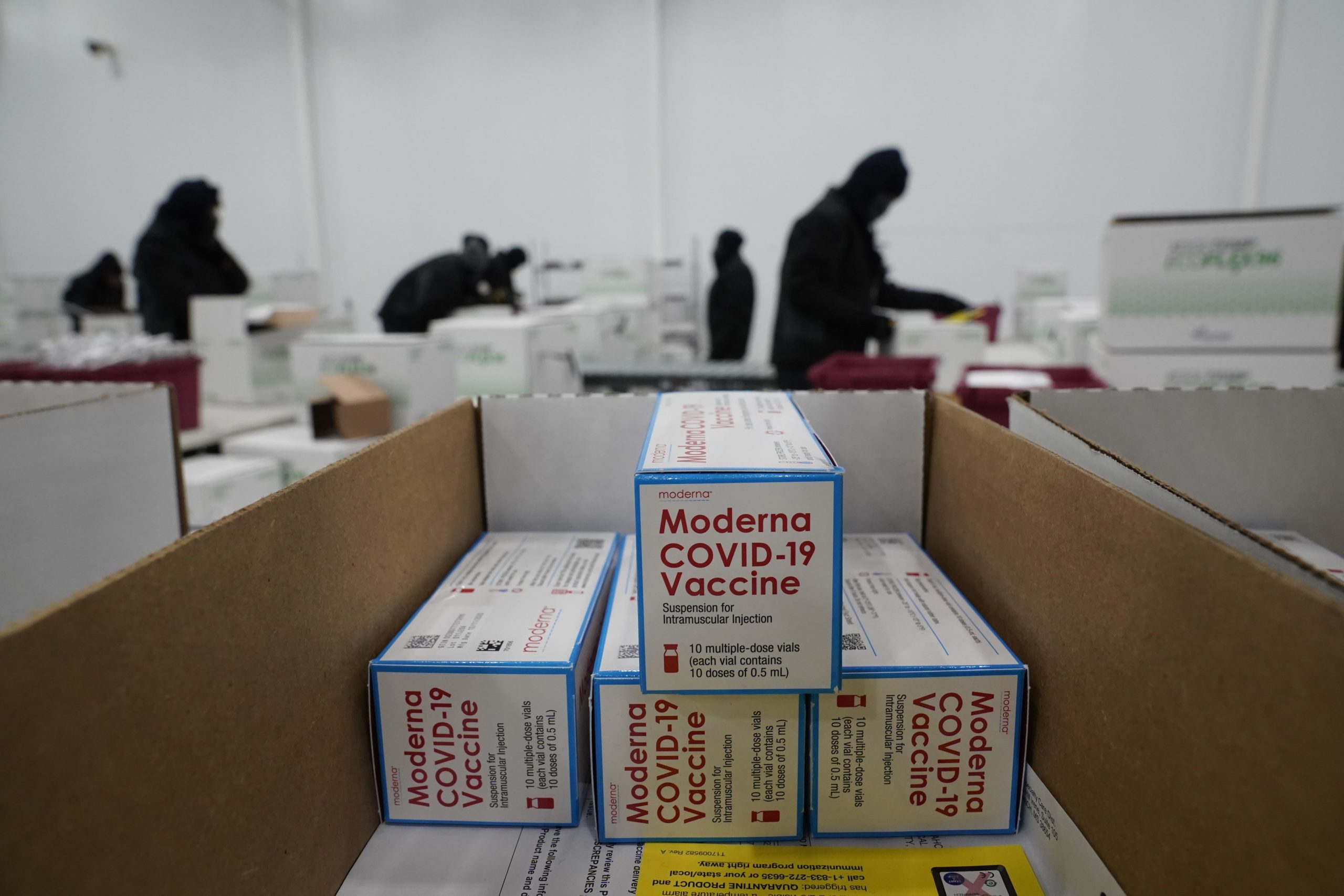 TOPSHOT - Boxes containing the Moderna Covid-19 vaccine are prepared to be shipped at the McKesson distribution center in Olive Branch, Mississippi, on December 20, 2020. (Photo by Paul Sancya / POOL / AFP) (Photo by PAUL SANCYA/POOL/AFP via Getty Images)