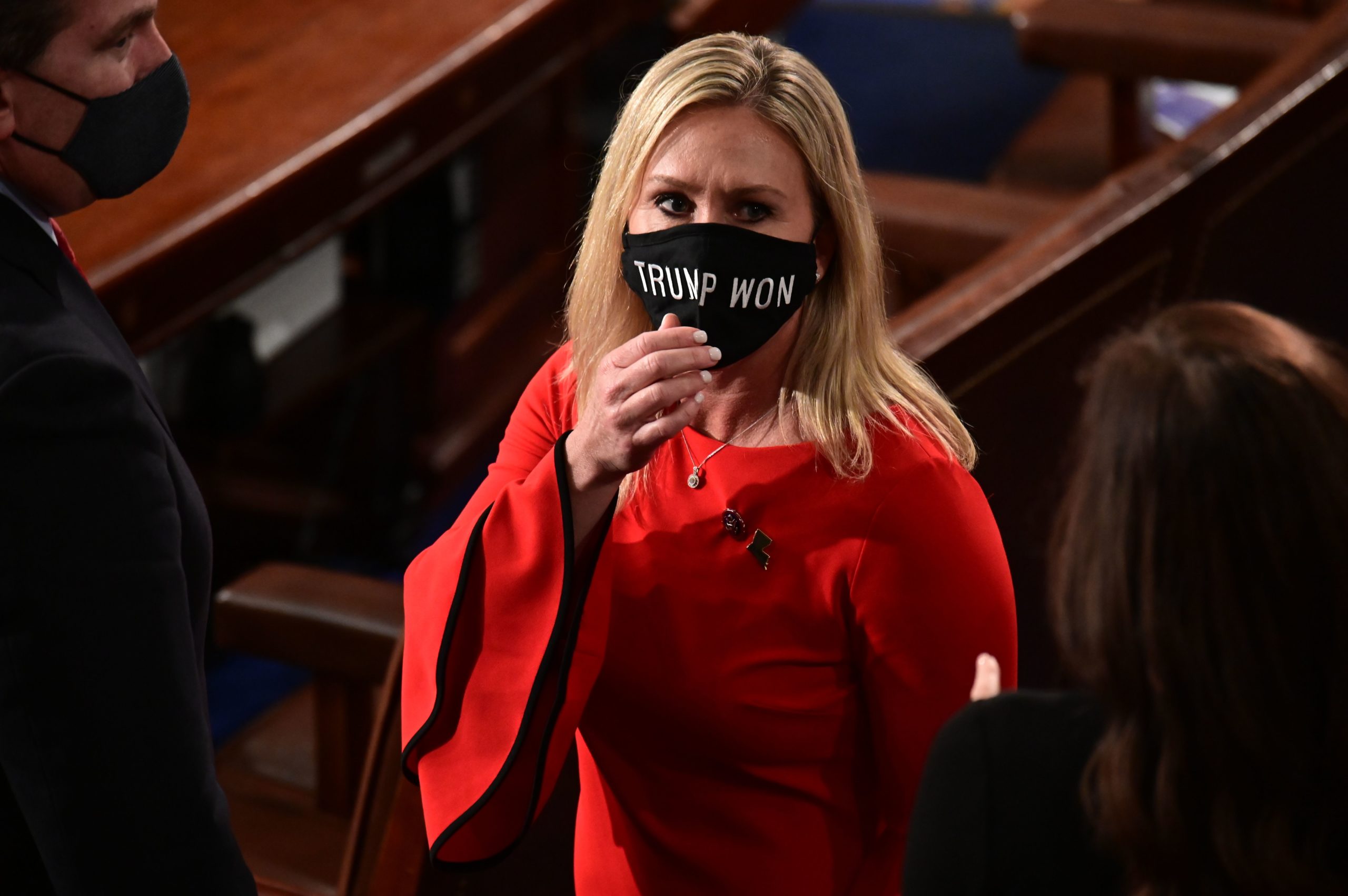 US Rep. Marjorie Taylor Greene (R-GA) wears a "Trump Won" face mask as she arrives on the floor of the House to take her oath of office as a newly elected member of the 117th House of Representatives in Washington, DC on January 3, 2021. (Photo by ERIN SCOTT / POOL / AFP) (Photo by ERIN SCOTT/POOL/AFP via Getty Images)
