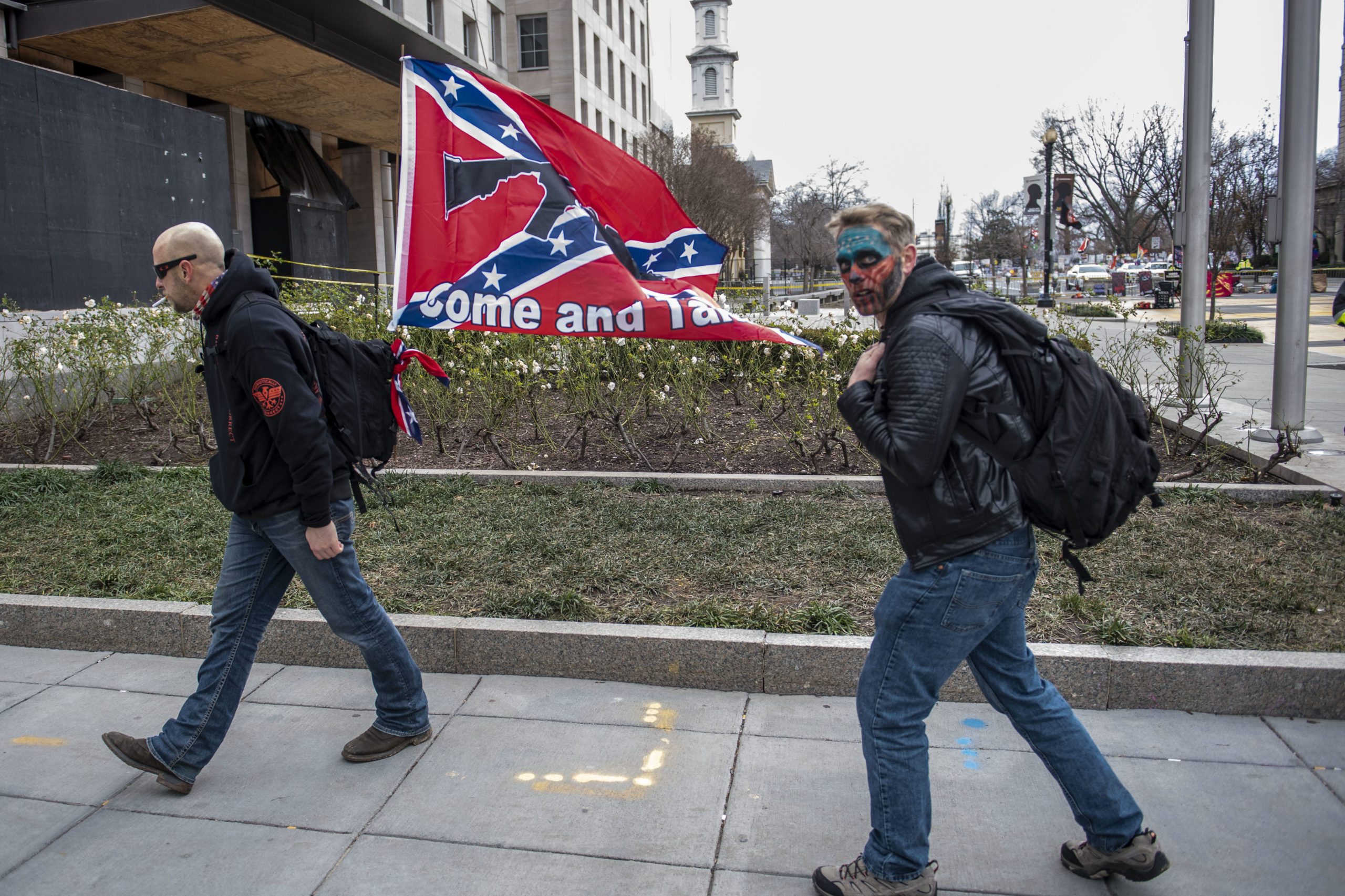 A supporter of US President Donald Trump display a Confederate flag next to Black Lives Matter Plaza as supporters from around the country rally in the US Capital to protest the upcoming electoral college certification of Joe Biden as President in Washington, DC on January 6, 2021. (Photo by Eric BARADAT / AFP) (Photo by ERIC BARADAT/AFP via Getty Images)