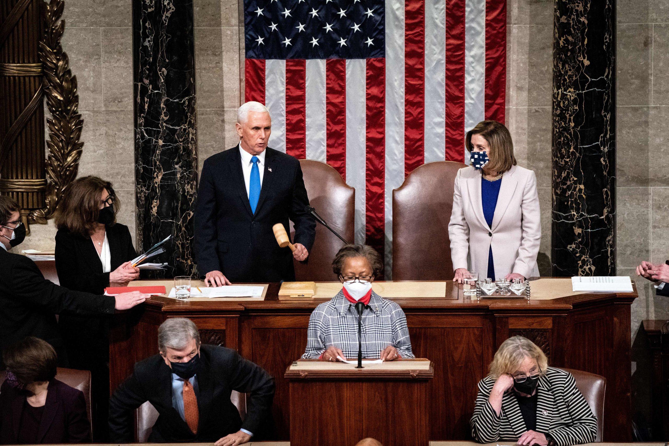 TOPSHOT - Vice President Mike Pence and House Speaker Nancy Pelosi preside over a Joint session of Congress to certify the 2020 Electoral College results after supporters of President Donald Trump stormed the Capitol earlier in the day on Capitol Hill in Washington, DC on January 6, 2021. - Members of Congress returned to the House Chamber after being evacuated when protesters stormed the Capitol and disrupted a joint session to ratify President-elect Joe Biden's 306-232 Electoral College win over President Donald Trump. (Photo by Erin Schaff / POOL / AFP) (Photo by ERIN SCHAFF/POOL/AFP via Getty Images)