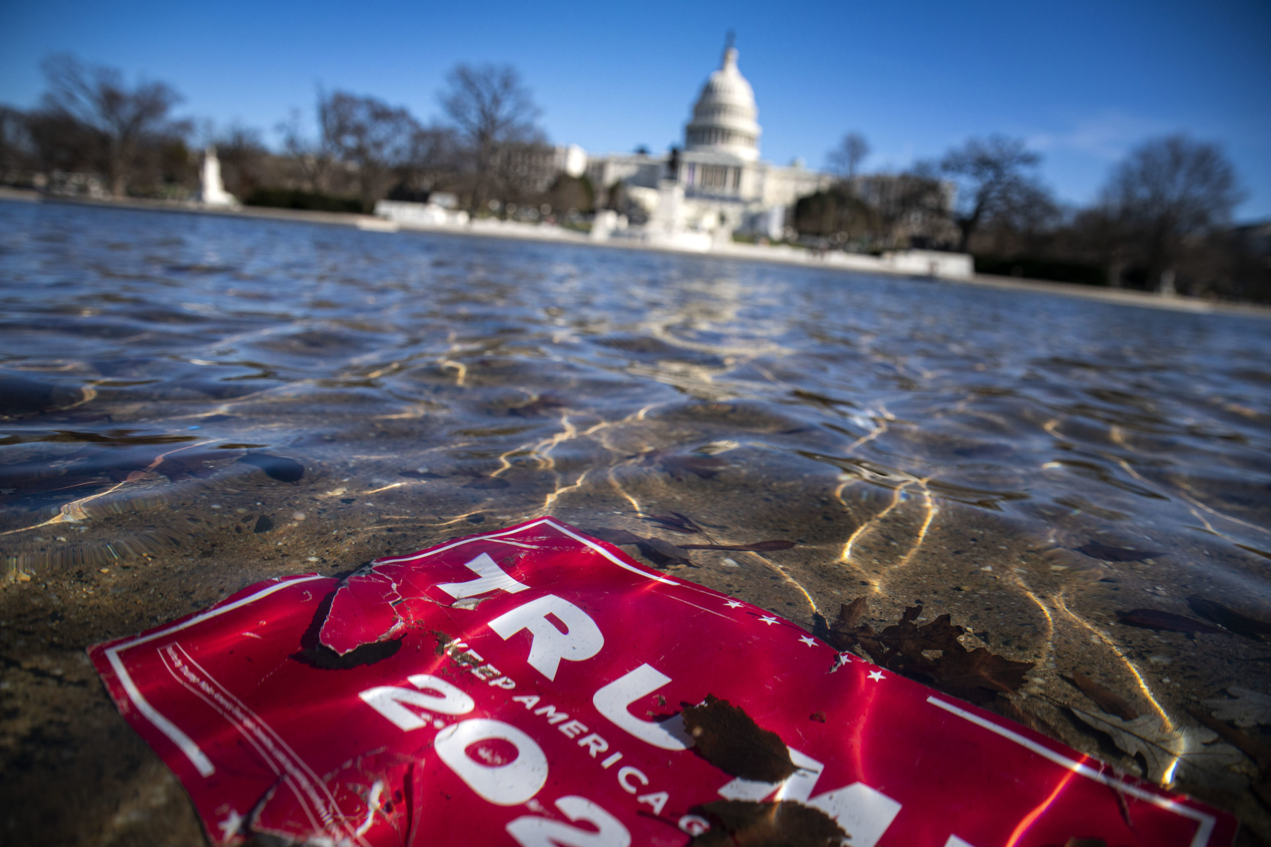WASHINGTON, DC - JANUARY 09: A campaign sign for U.S. President Donald Trump lies beneath water in the Capitol Reflecting Pool, on Capitol Hill on January 9, 2021 in Washington, DC. A pro-Trump mob stormed and desecrated the U.S. Capitol on January 6 as Congress held a joint session to ratify President-elect Joe Biden's 306-232 Electoral College win over President Donald Trump. (Photo by Al Drago/Getty Images)