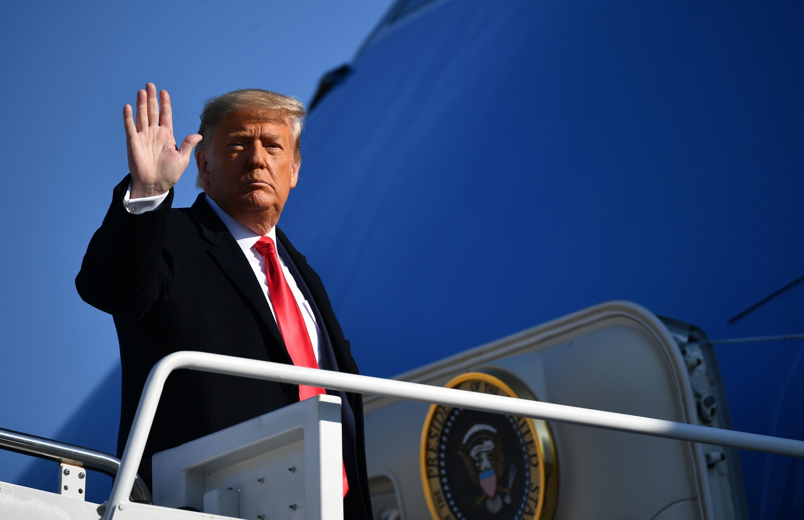 US President Donald Trump waves to the media as he makes his way to board Air Force One before departing from Andrews Air Force Base in Maryland on January 12, 2021. - Trump is traveling to Texas to review his border wall project. (Photo by MANDEL NGAN/AFP via Getty Images)