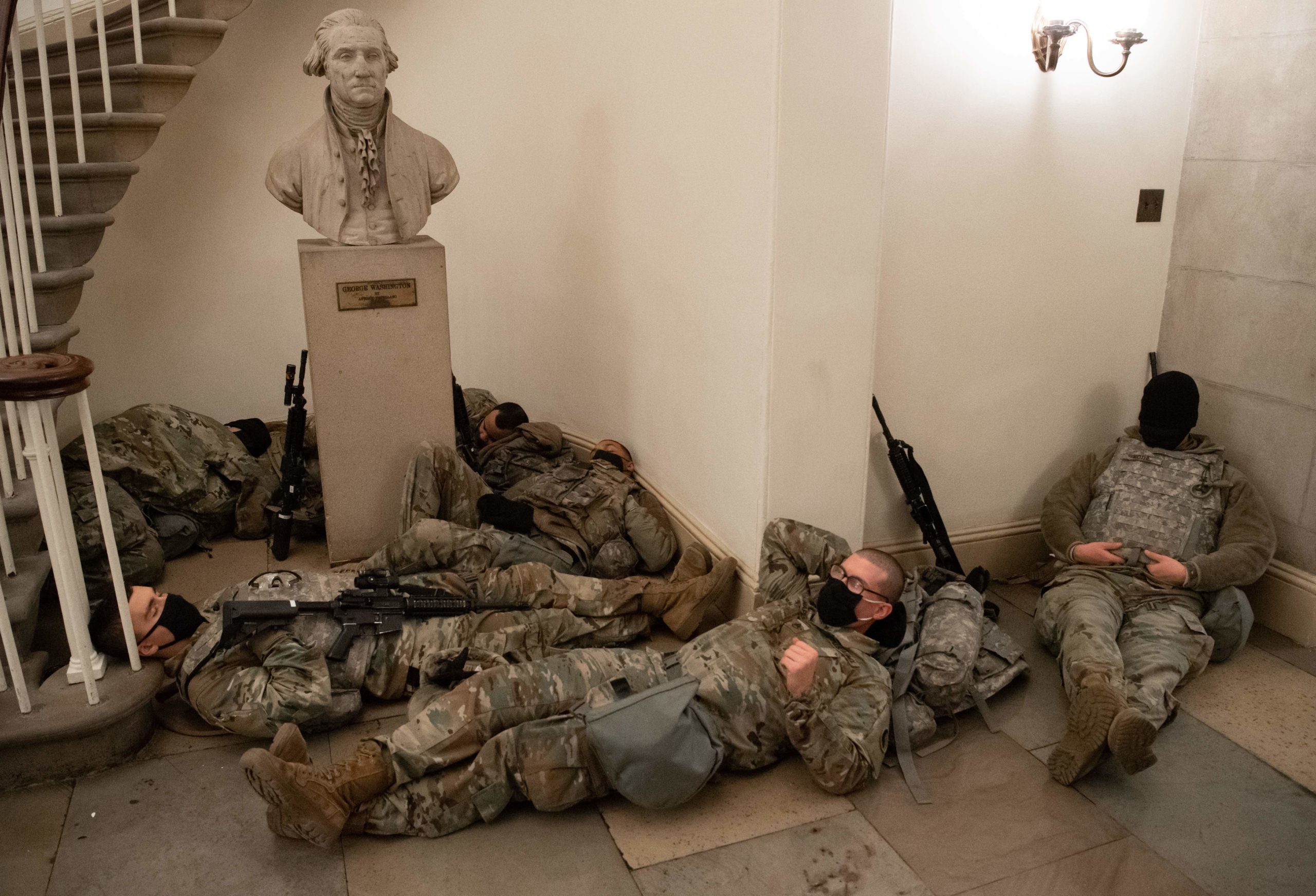 Members of the National Guard take a rest in the Rotunda of the US Capitol in Washington, DC, January 13, 2021, ahead of an expected House vote impeaching US President Donald Trump. - The Democrat-controlled US House of Representatives on Wednesday opened debate on a historic second impeachment of President Donald Trump over his supporters' attack of the Capitol that left five dead.Lawmakers in the lower chamber are expected to vote for impeachment around 3:00 pm (2000 GMT) -- marking the formal opening of proceedings against Trump. (Photo by Saul Loeb/AFP via Getty Images)