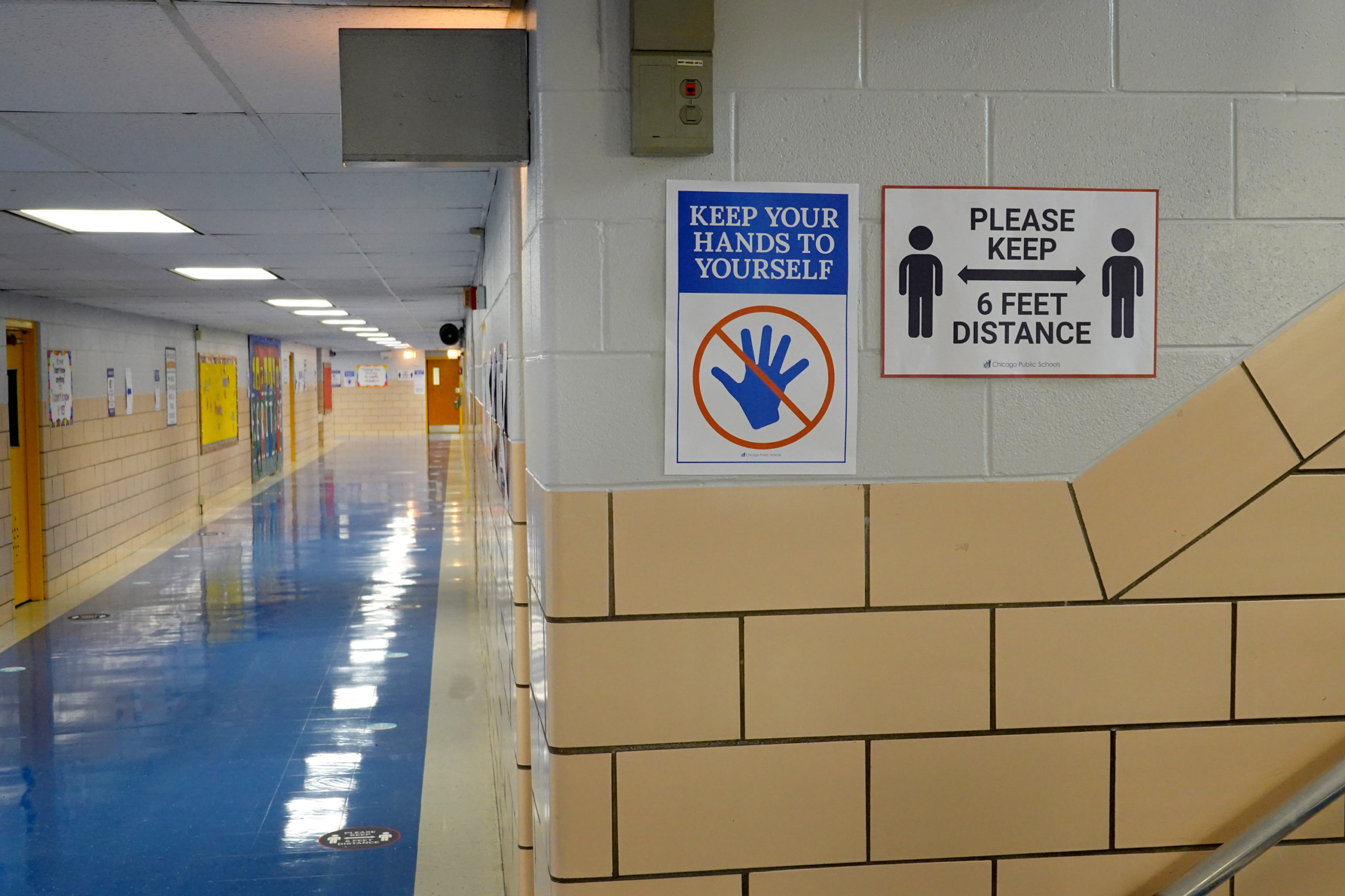 Signs in a hallway at a Chicago public school encourage social distancing. (Scott Olson/Getty Images)