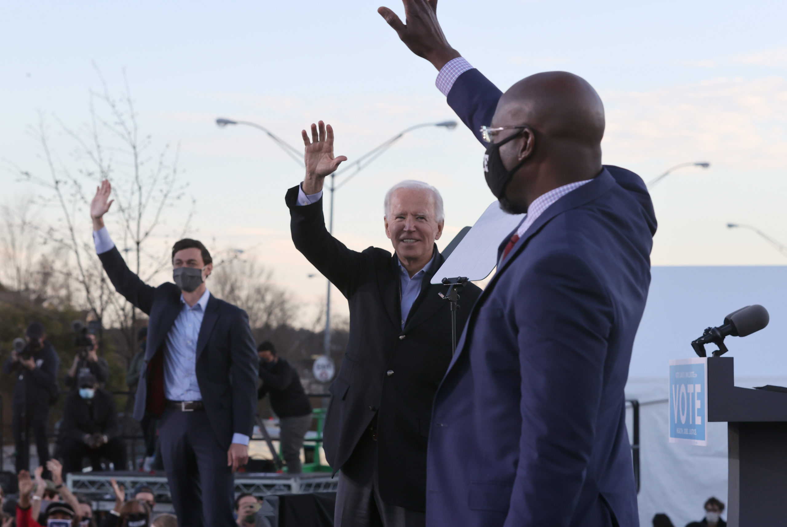 President-elect Joe Biden along with Jon Ossoff and Rev. Raphael Warnock greet supporters during a campaign rally Monday in Atlanta, Georgia. (Chip Somodevilla/Getty Images)