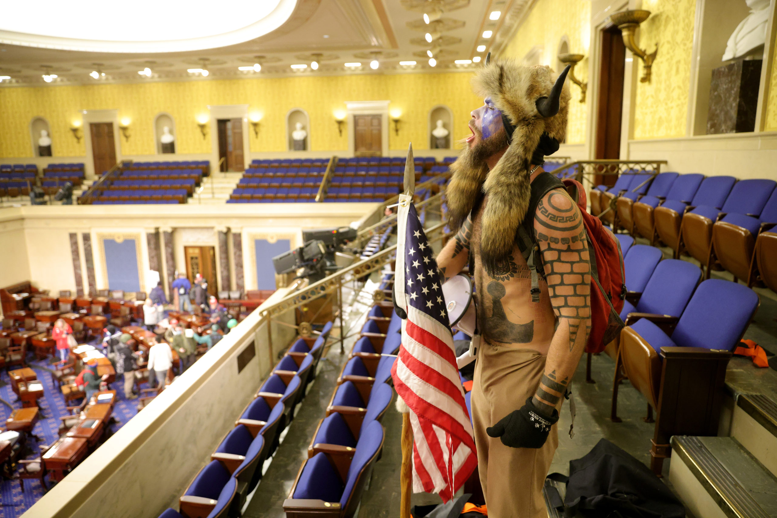 WASHINGTON, DC - JANUARY 06: A protester yells inside the Senate Chamber on January 06, 2021 in Washington, DC. Congress held a joint session today to ratify President-elect Joe Biden's 306-232 Electoral College win over President Donald Trump. Pro-Trump protesters entered the U.S. Capitol building during mass demonstrations in the nation's capital. (Photo by Win McNamee/Getty Images)