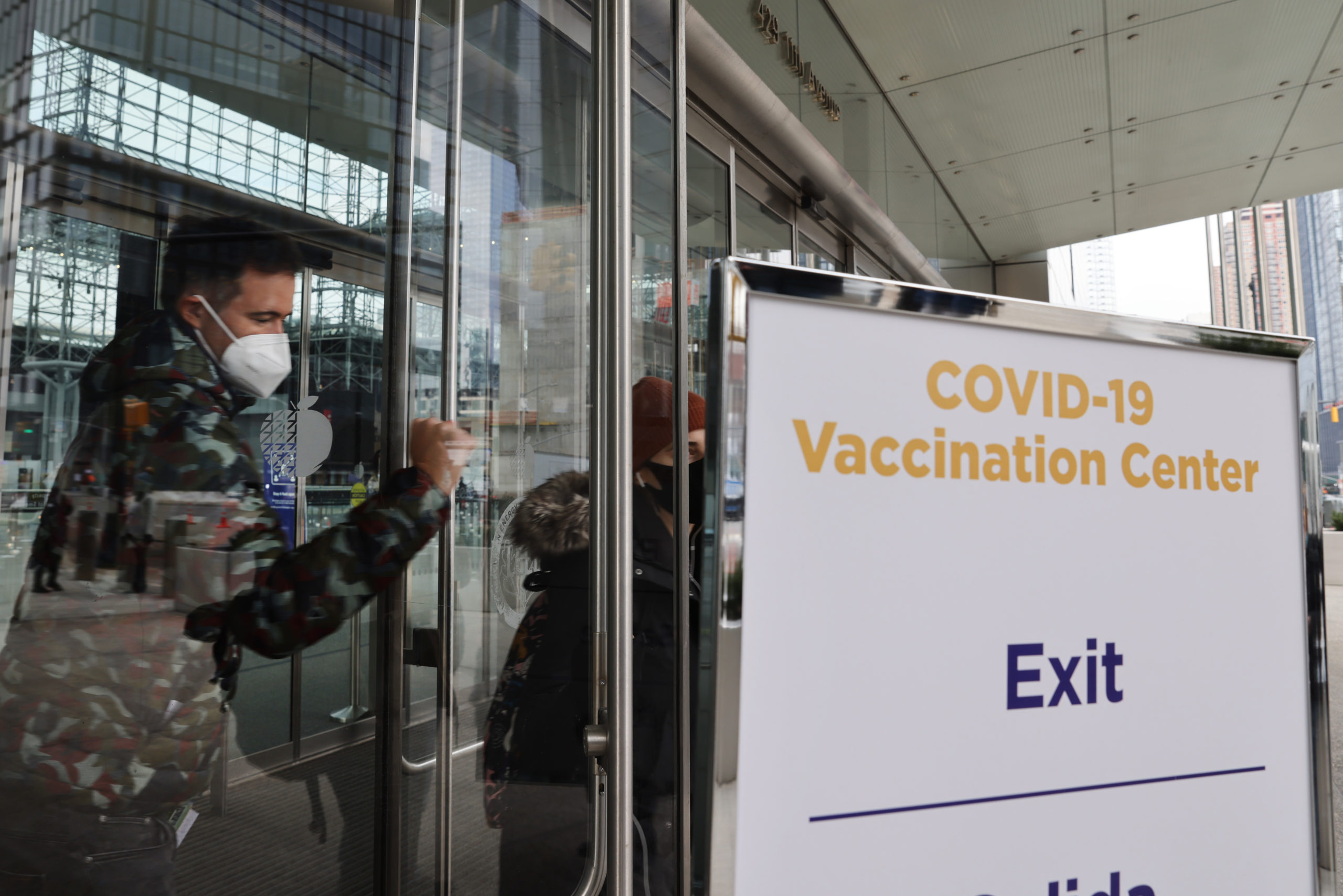 People walk out of Manhattan’s Javits Center which recently opened as a COVID vaccination site on Wednesday in New York City. (Spencer Platt/Getty Images)