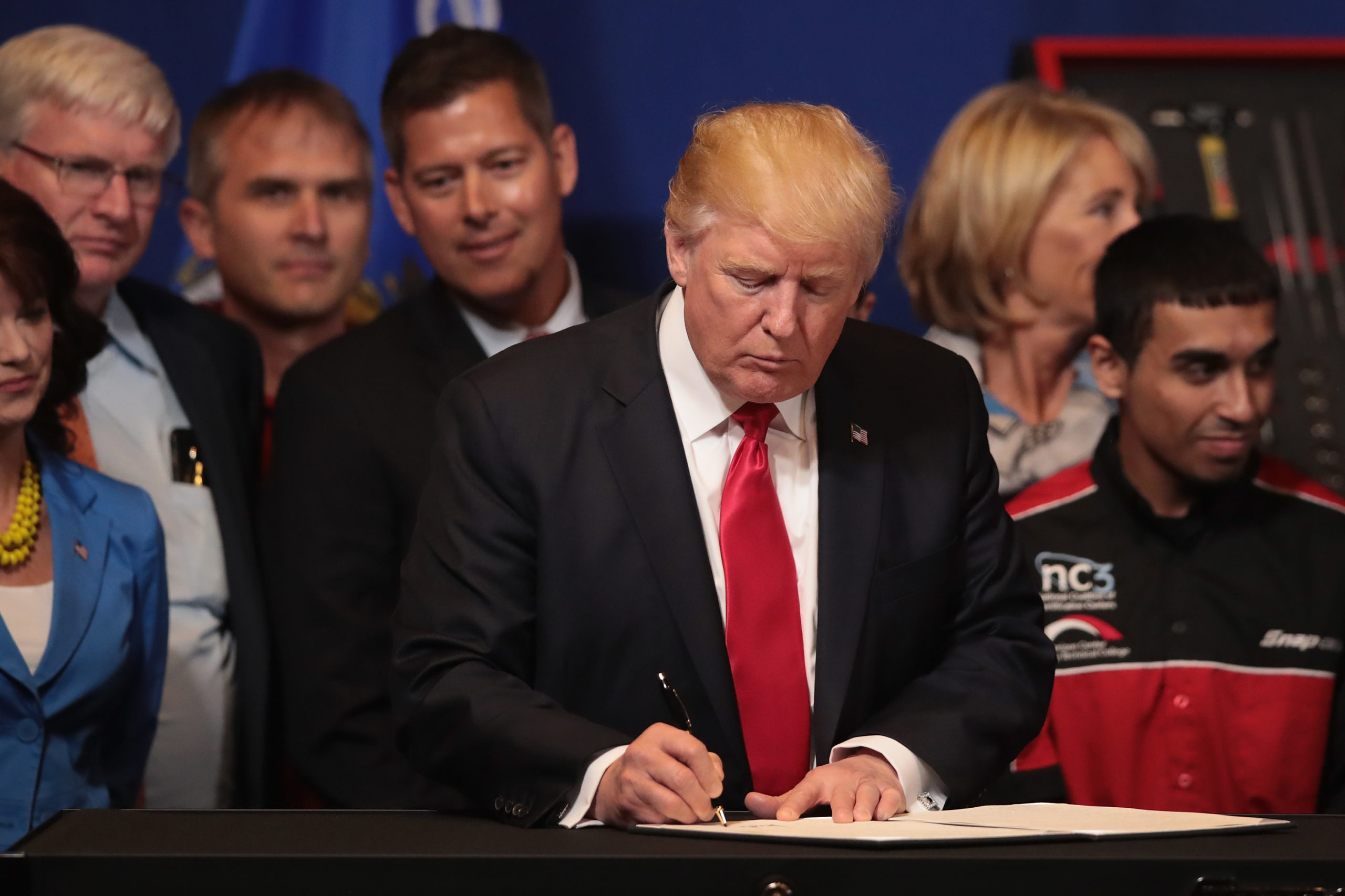 KENOSHA, WI - APRIL 18: President Donald Trump signs an executive order to try to bring jobs back to American workers and revamp the H-1B visa guest worker program during a visit to the headquarters of tool manufacturer Snap-On on April 18, 2017 in Kenosha, Wisconsin. (Photo by Scott Olson/Getty Images)