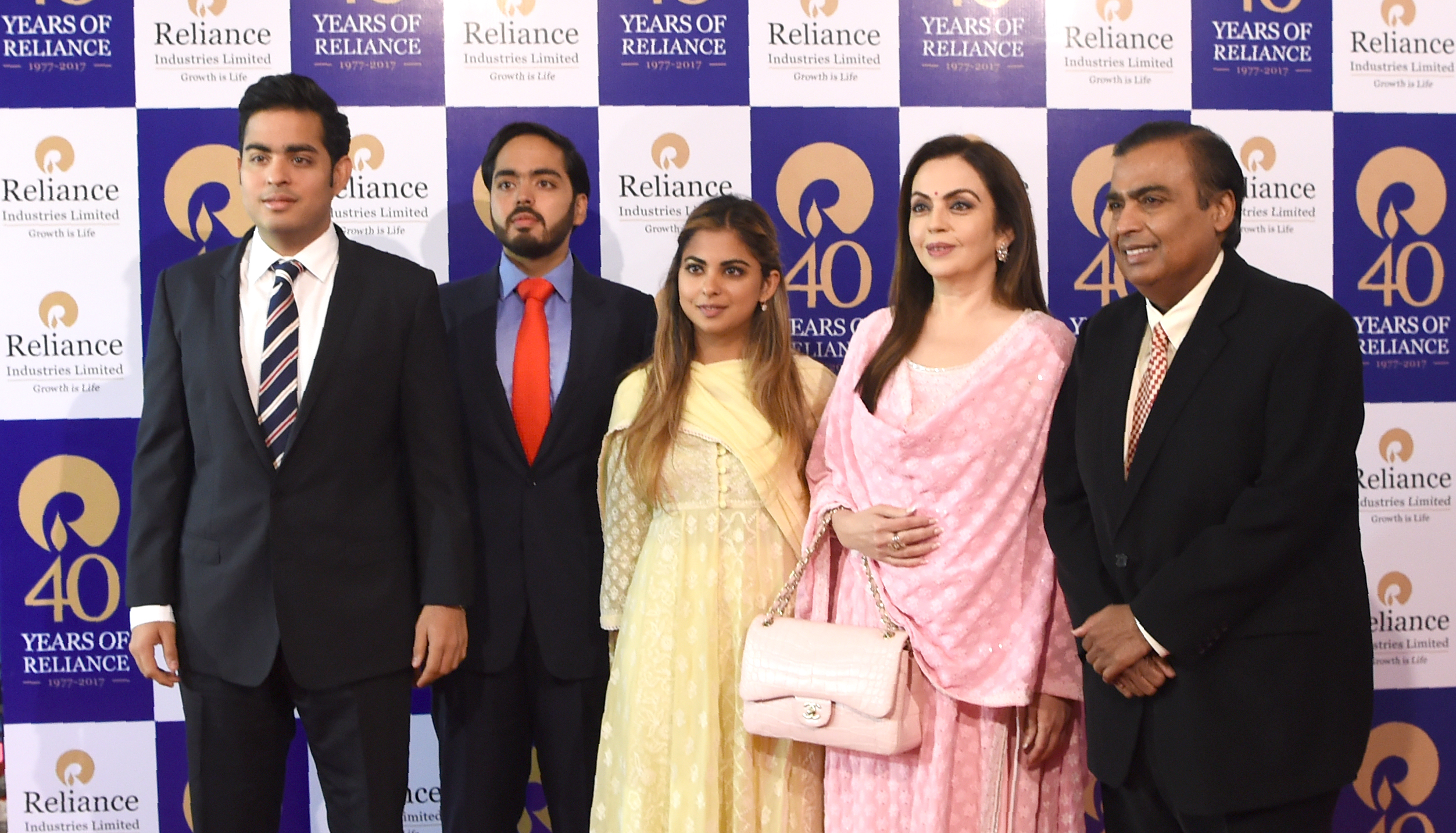 India's richest man and oil-to-telecom conglomerate Reliance Industries chairman Mukesh Ambani (R) and his wife Nita Ambani (2R) pose with their children (L-C) Akash Ambani, Anant Ambani and Isha Ambani as they arrive for the company's 40th AGM in Mumbai on July 21, 2017. (INDRANIL MUKHERJEE/AFP via Getty Images)