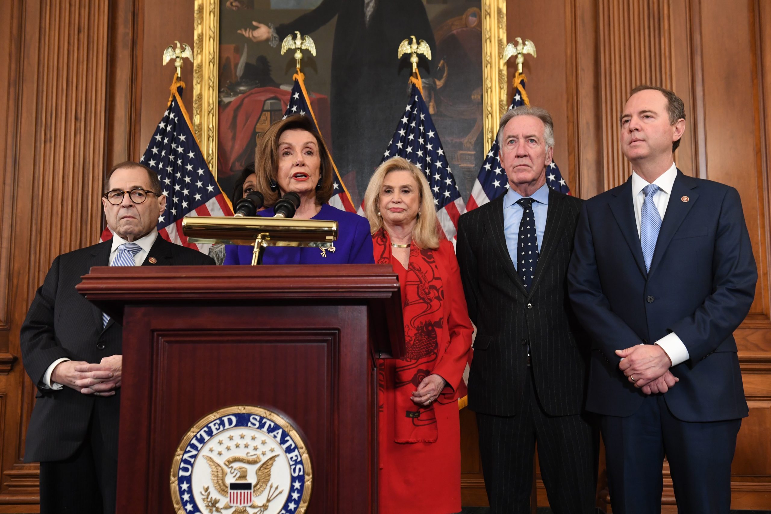 Speaker of the House Nancy Pelosi (C), flanked by House Permanent Select Committee on Intelligence Chairman Adam Schiff (R)(D-CA), House Judiciary Chairman Jerry Nadler (L) (D-NY), House Foreign Affairs Committee Chairman Eliot Engel (2ndR) (D-NY), House Financial Services Committee Chairwoman Maxine Waters (background)(D-CA), and House Committee on Oversight and Reform Chairwoman Carolyn Maloney (2nd R) (D-NY), speaks as Democrats announced articles of impeachment against US President Donald Trump during a press conference at the US Capitol in Washington, DC, December 10, 2019 listing abuse of power and obstruction of Congress. (Photo by SAUL LOEB / AFP) (Photo by SAUL LOEB/AFP via Getty Images)