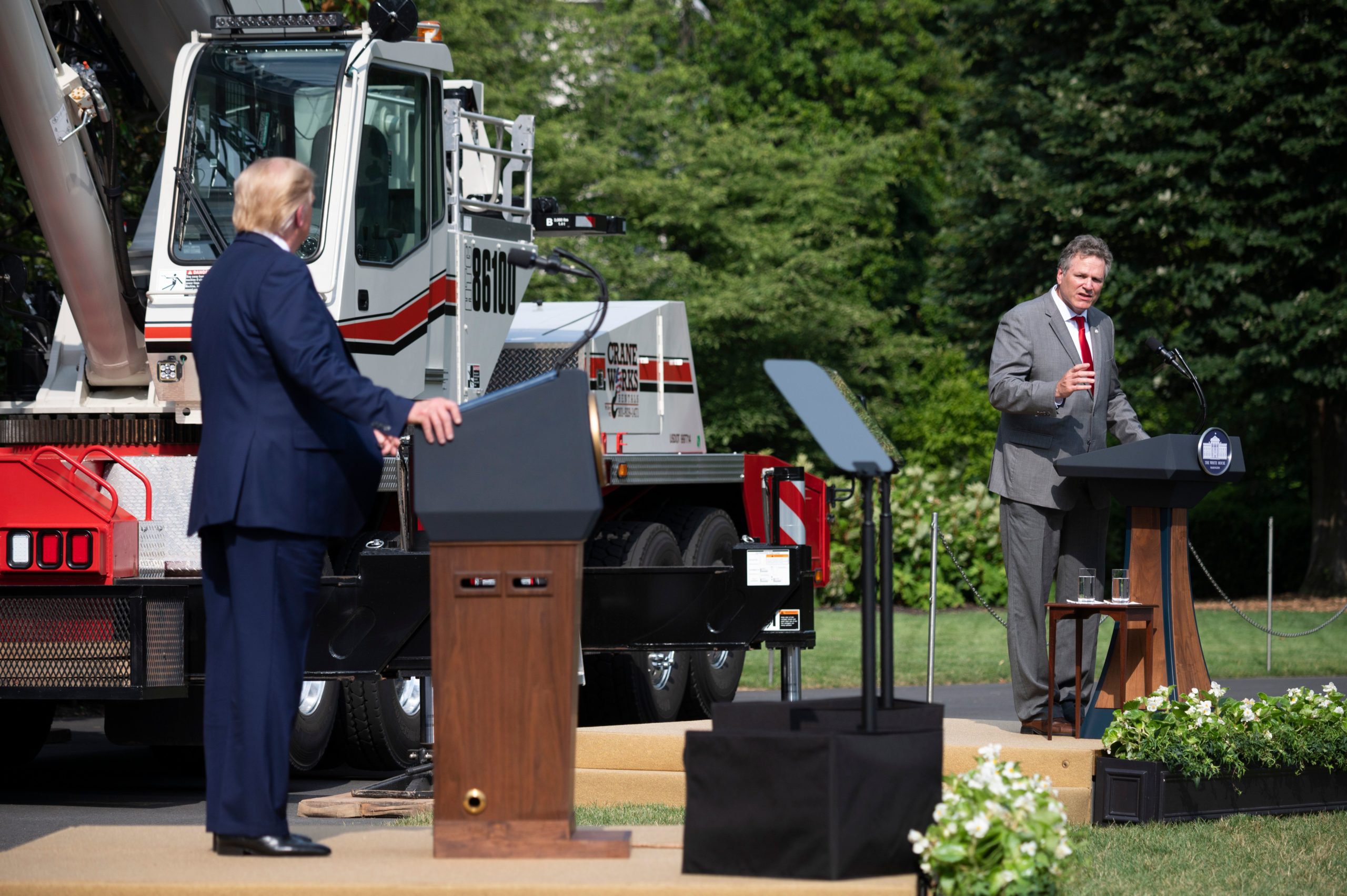 US President Donald Trump(L0 listens as Alaska Governor Mike Dunleavy (R-AK) speaks at the White House in Washington, DC, on July 16, 2020, during an event on Rolling Back Regulations to Help All Americans on the South Lawn at the White House on July 16, 2020 in Washington,DC. (Photo by JIM WATSON / AFP) (Photo by JIM WATSON/AFP via Getty Images)