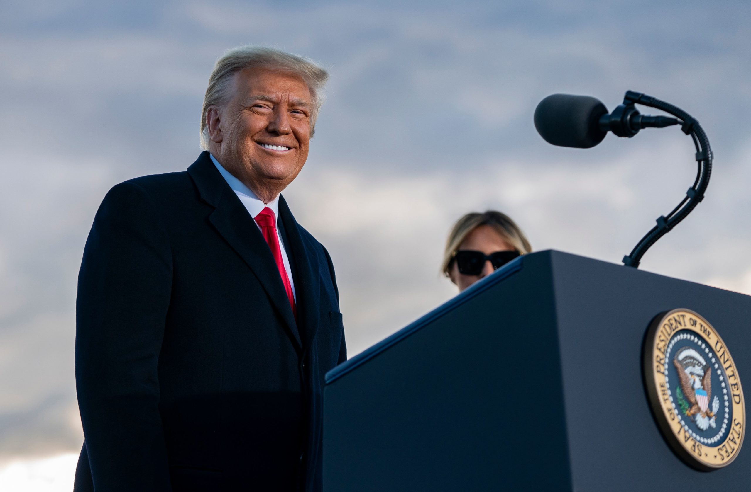 Outgoing US President Donald Trump and First Lady Melania Trump address guests at Joint Base Andrews in Maryland on January 20, 2021. - President Trump and the First Lady travel to their Mar-a-Lago golf club residence in Palm Beach, Florida, and will not attend the inauguration for President-elect Joe Biden. (Photo by ALEX EDELMAN/AFP via Getty Images)