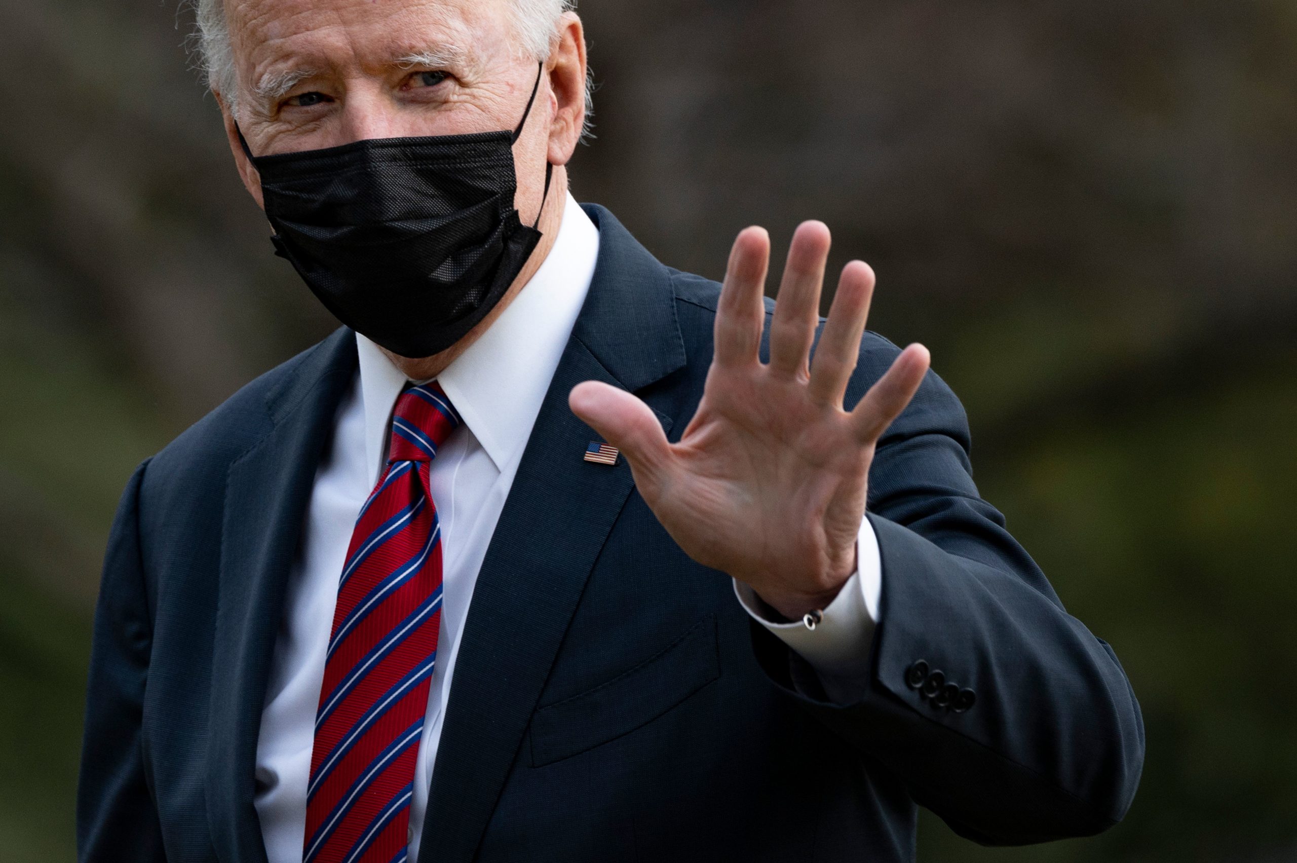 US President Joe Biden waves as he arrives at the White House in Washington, DC, on January 29, 2021. - Biden visited on Friday wounded military members and a coronavirus vaccine site at Walter Reed National Military Medical Center in Bethesda, Maryland. (Photo by JIM WATSON/AFP via Getty Images)