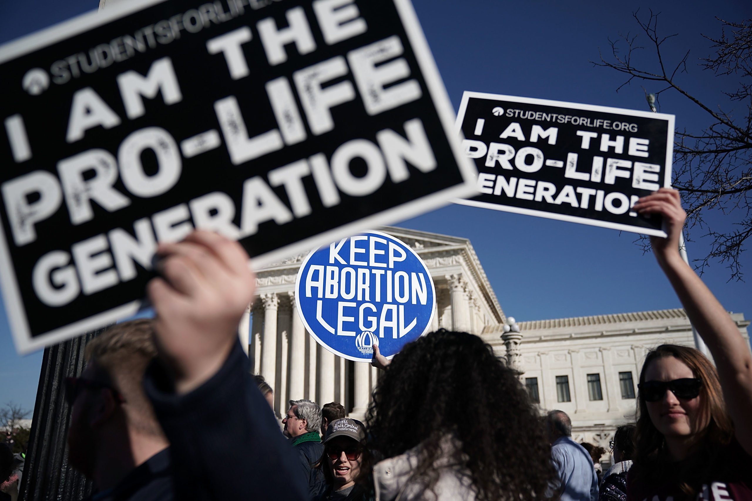WASHINGTON, DC - JANUARY 19: Pro-life activists try to block the sign of a pro-choice activist during the 2018 March for Life January 19, 2018 in Washington, DC. Activists gathered in the nation's capital for the annual event to protest the anniversary of the Supreme Court Roe v. Wade ruling that legalized abortion in 1973. (Photo by Alex Wong/Getty Images)