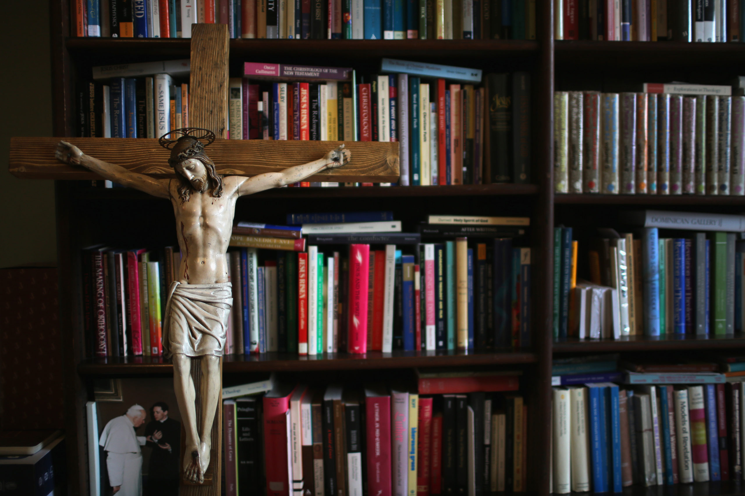 BIRMINGHAM, ENGLAND - AUGUST 11:A crucifx leans against religious academic books at Oscott College on May 8, 2014 in Birmingham, England. St. Mary's College, Oscott opened in 1794 and was designed by the gothic architect Augustus Welby Pugin. The formation for catholic priesthood takes six years living in the college of seminarians dedicated to prayer, study and pastoral work in the local community. During the first three years a seminarian progresses to the ministries of Lector and Acolyte, in readiness for a pastoral role in his home diocese. the seminarian returns to his studies and at the end of his fourth year is accepted as a candidate for Holy Orders. After five years he is ordained a deacon in the college chapel and, finally ordained priest in his home diocese at the end of his sixth year. (Photo by Christopher Furlong/Getty Images)