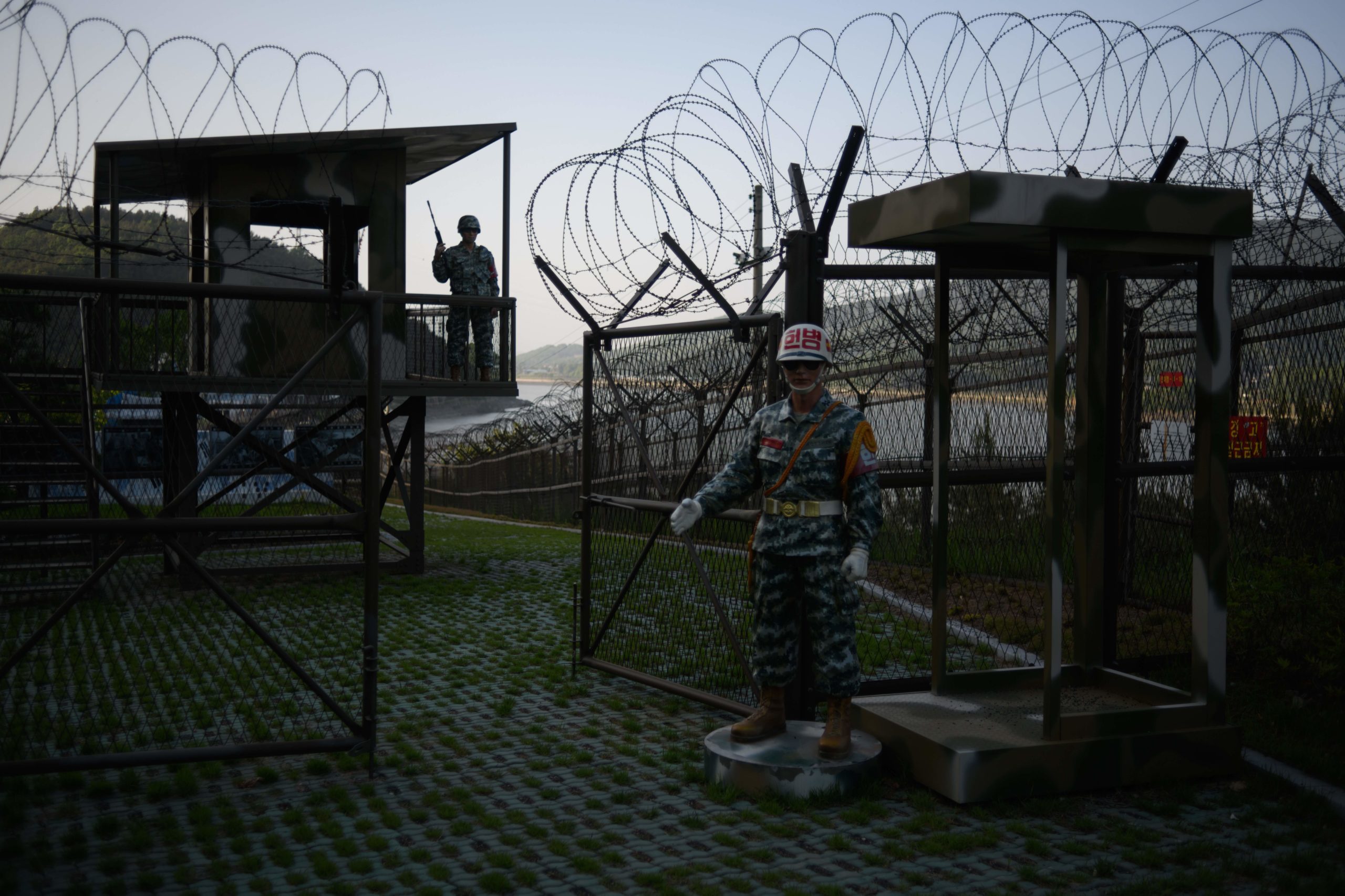 Mannequins of South Korean soldiers stand before a guard post open to visitors, beside the barbed wire fence of the Demilitarized Zone (DMZ) between North and South Korea on Ganghwa island on May 24, 2018. (ED JONES/AFP via Getty Images)
