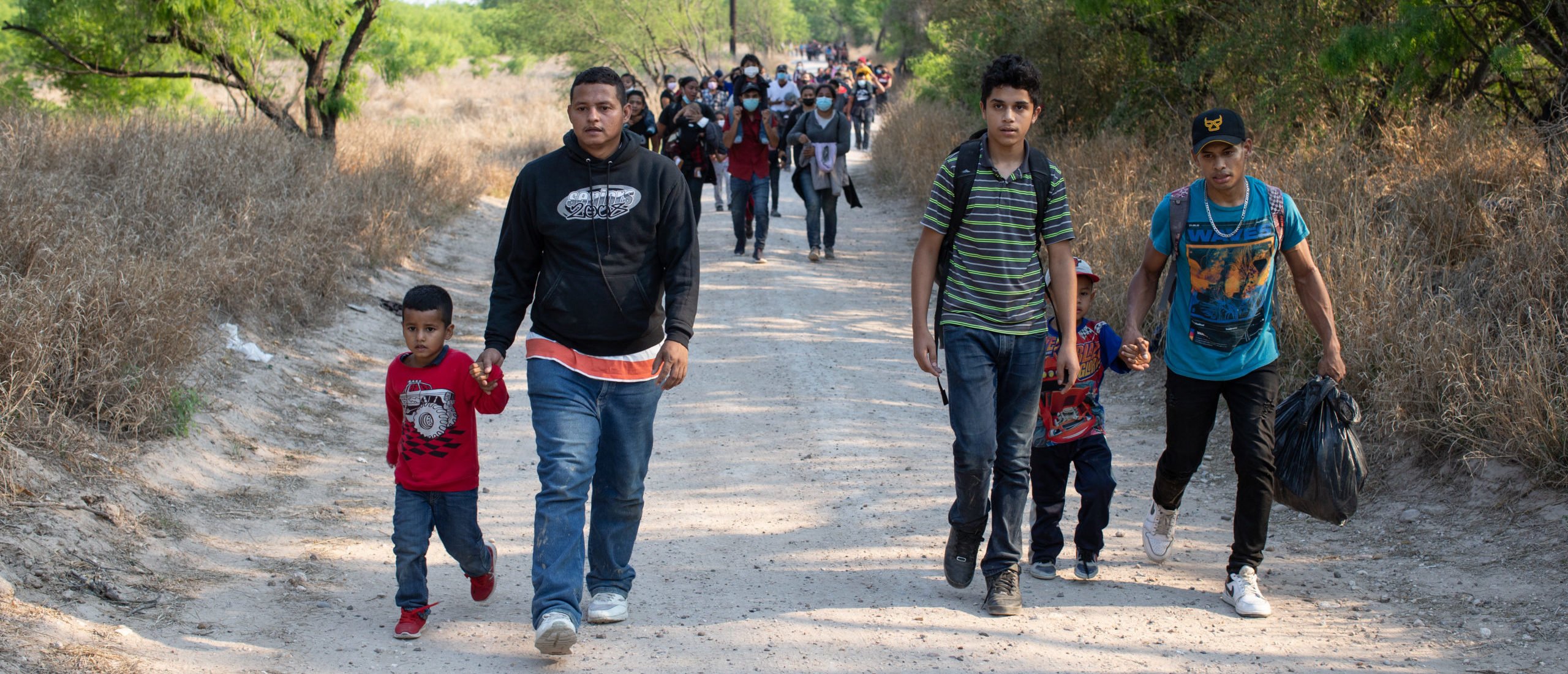 Illegal migrants use a road on private land to access a Customs and Border Protection field processing facility under the Anzalduas International Bridge near Mission, Texas, on March 26, 2021. (Kaylee Greenlee - Daily Caller News Foundation)